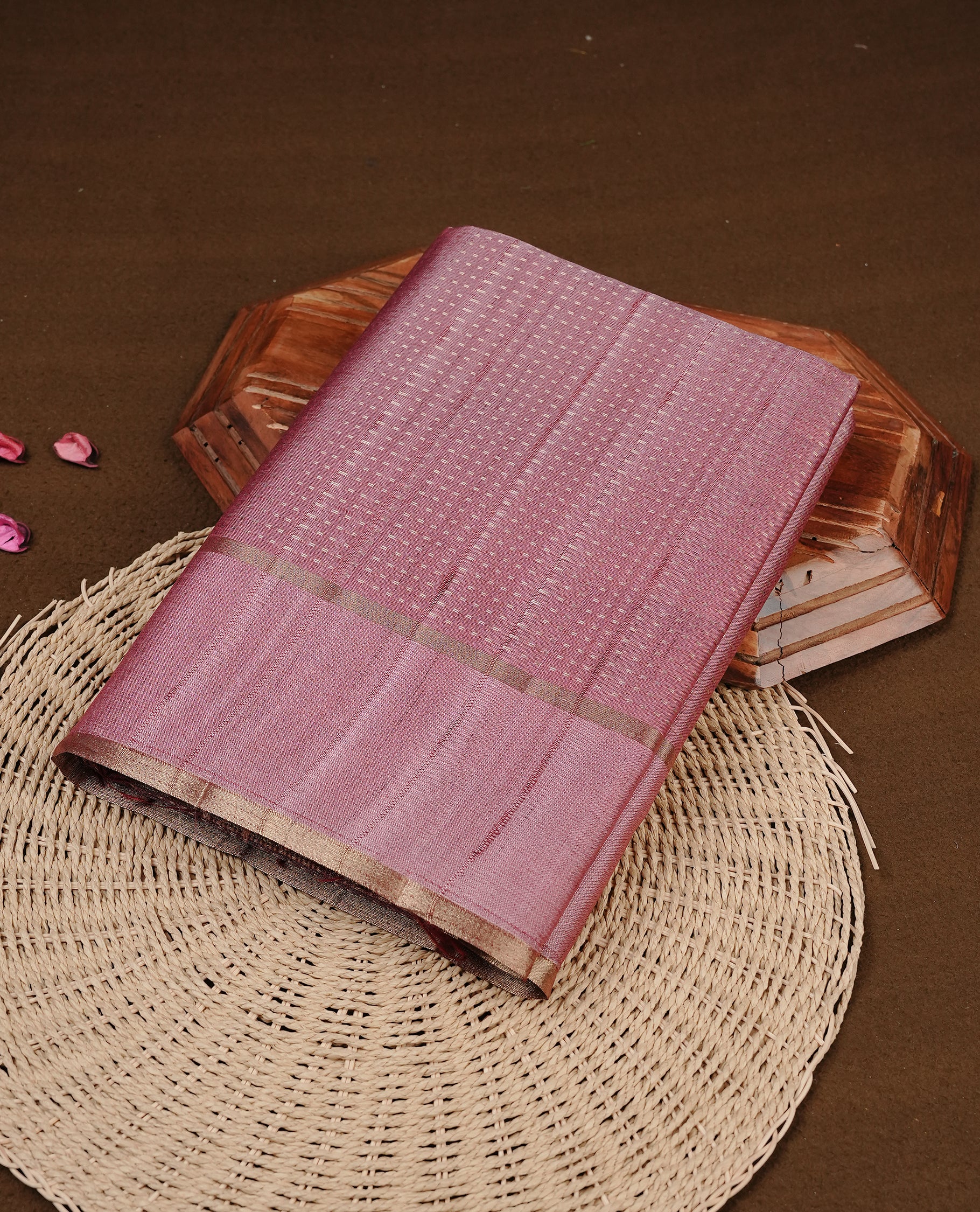 Mauve colour semi tussar silk saree featuring elegant gold zari dotted stripes across the body, enhanced with a rich zari woven border. Comes with a matching blouse piece.