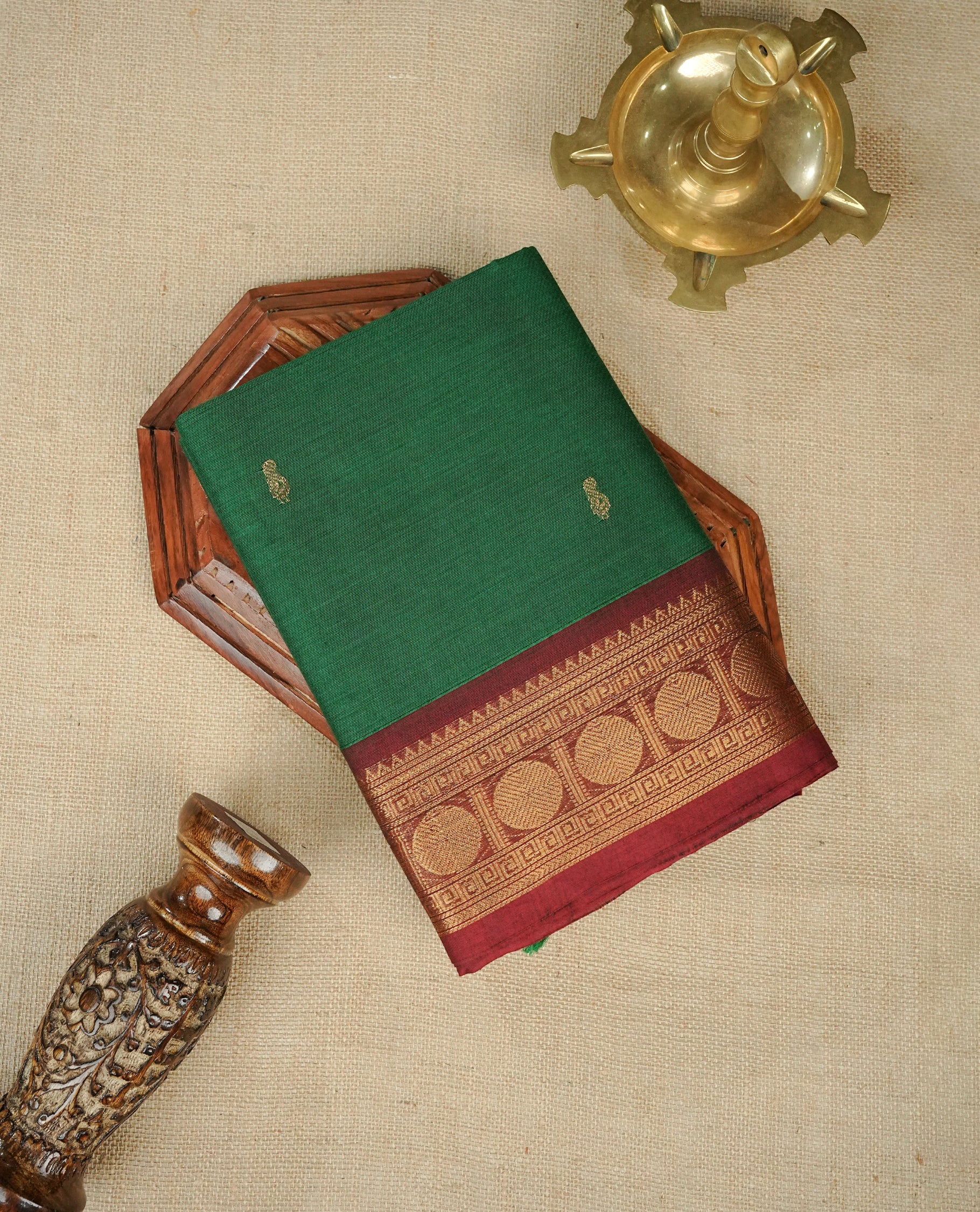 Green colour chettinad saree featuring gold zari motifs on body, complemented by contrast Maroon colour with gold zari border, comes with matching blouse piece.