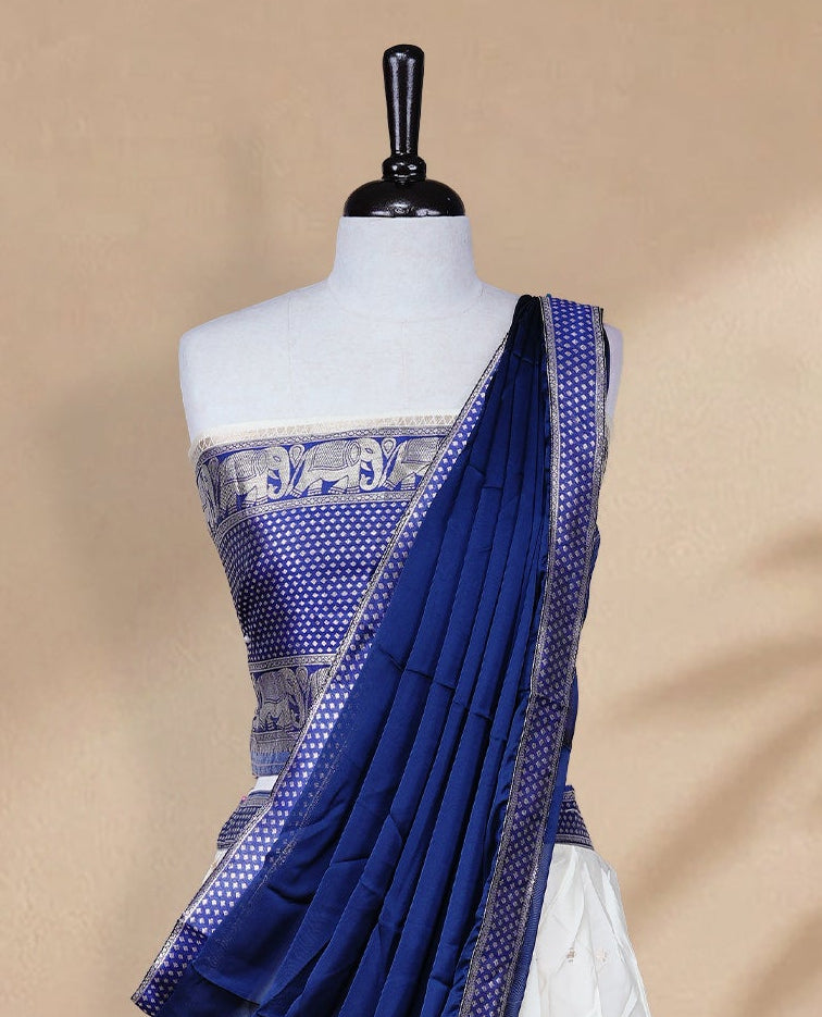 Cream colour Half saree featuring Gold zari buttas on skirt with Zari border on contrast Blue colour border, Unstitched Blouse and matching dupatta.