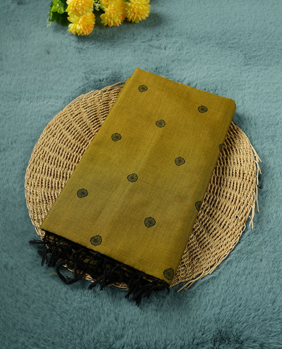 Olive green colour poly cotton saree with black abstract butti motifs on the body, paired with a matching pallu with dense black textured round butta pattern, and a coordinated all‑over textured round butta printed blouse piece.