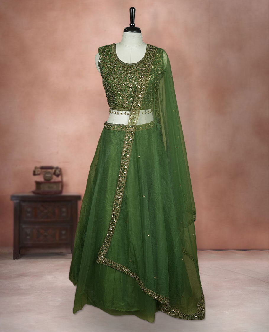Olive green colour lehenga set with stitched sleeveless Antique thread embroidered & beats worked blouse featuring sheer neckline, matching stitched flared lehenga, and plain sheer dupatta.