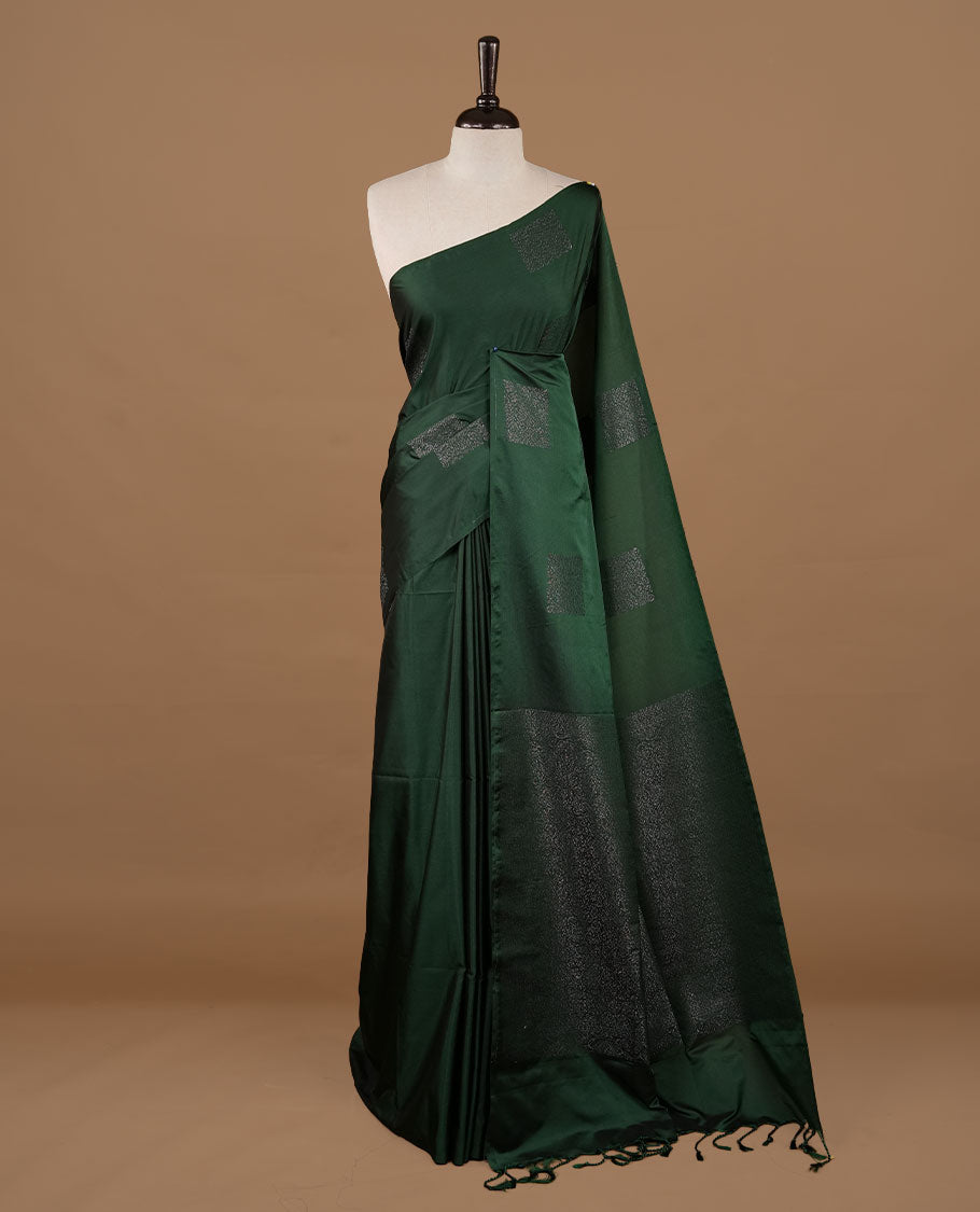 Green soft silk saree features a sleek borderless design with intricate antique zari motifs, flowing into a seamless self colored pallu and a matching blouse piece.