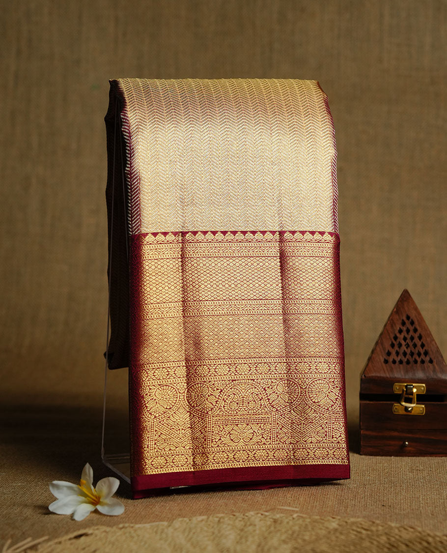 Gold & Maroon double shade colour kancheepuram tissue silk saree featuring gold zari stripeson pattern on body, complemented by contrast maroon colour with traditional border, paired with matching blouse piece.