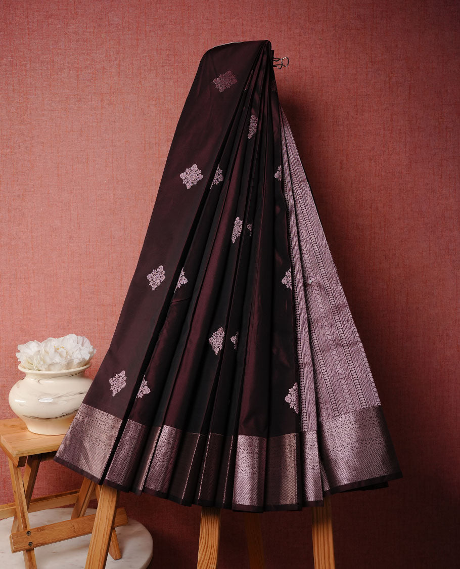 Chocolate brown colour soft silk saree featuring rose Gold zari motifs on body, complemented by self colour with traditional border, paired with matching blouse piece.