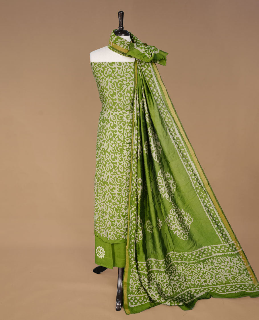 Pista green colour churidhar material featuring cream colour floral kodi print on body, paired with matching bottom and Dupatta.