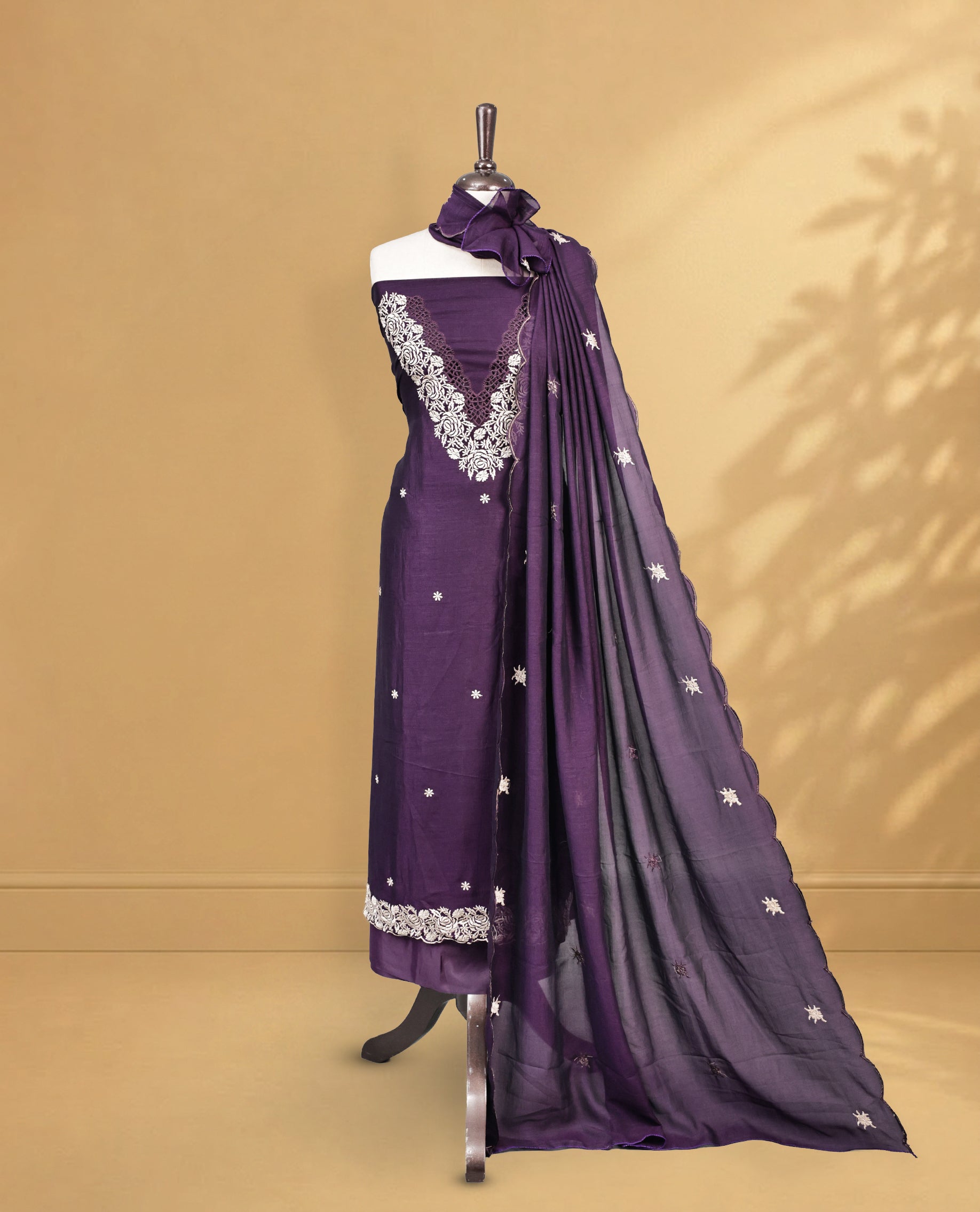 Purple colour Salwar Material Featuring Cream colour Thread pattern on Neckline & Small Buttas, paired with matching bottom & Same Colour Dupatta.