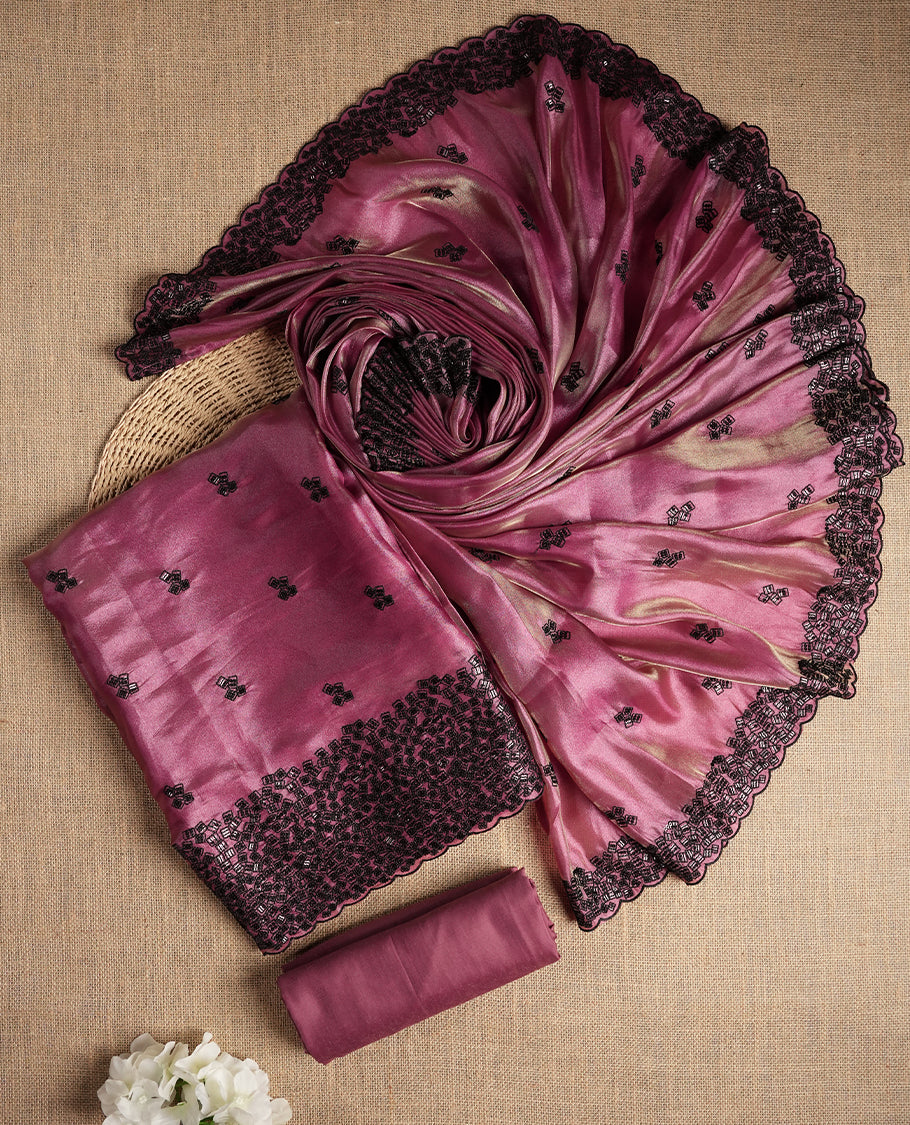 Charming mauve colour dual shaded suit material featuring intricate black thread and sequin embroidery with a delicate lace border, Paired with a matching embroidered dupatta and plain bottom.