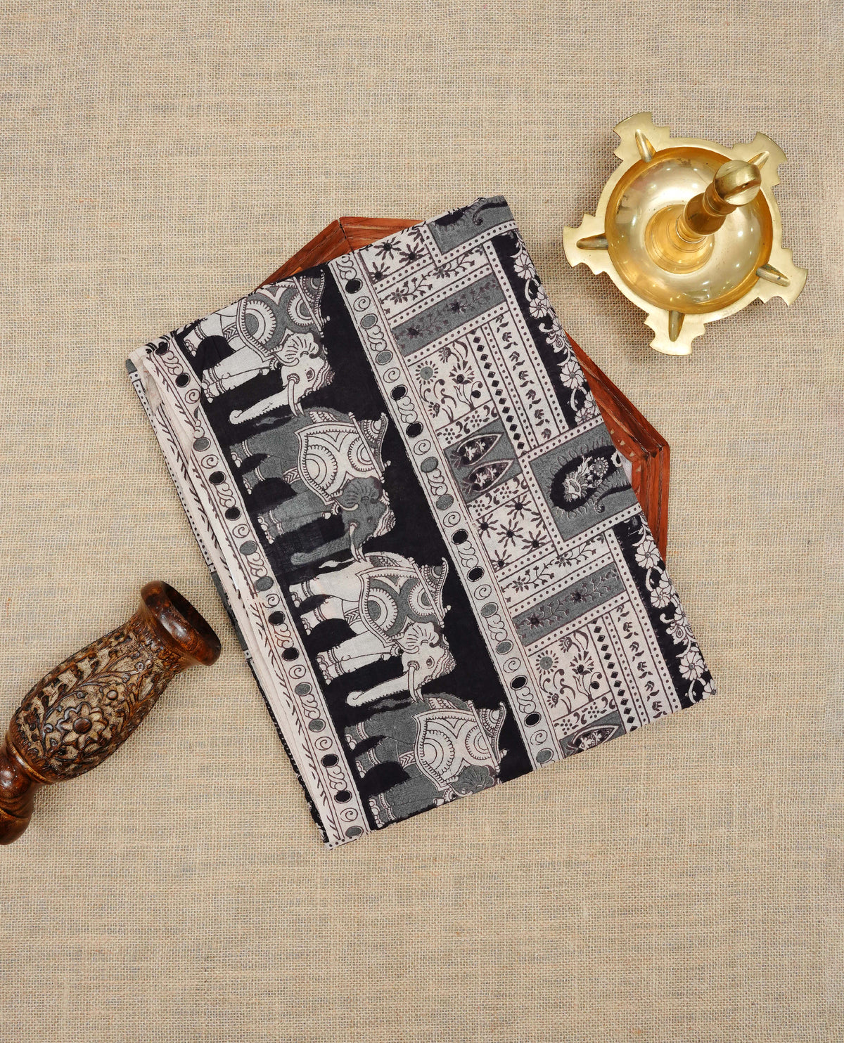 Black & cream colour kalamkari cotton saree featuring kalamkari printed body & pallu, paired with a matching contrast blouse piece.