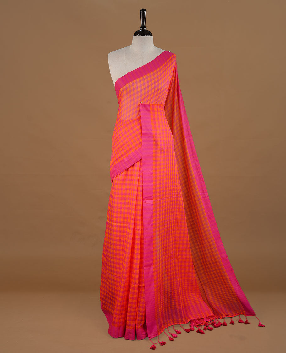 Orange and Pink colour Mul Cotton saree featuring a classic Big check pattern on the body, accented with tassels for added charm. Comes without a blouse piece.