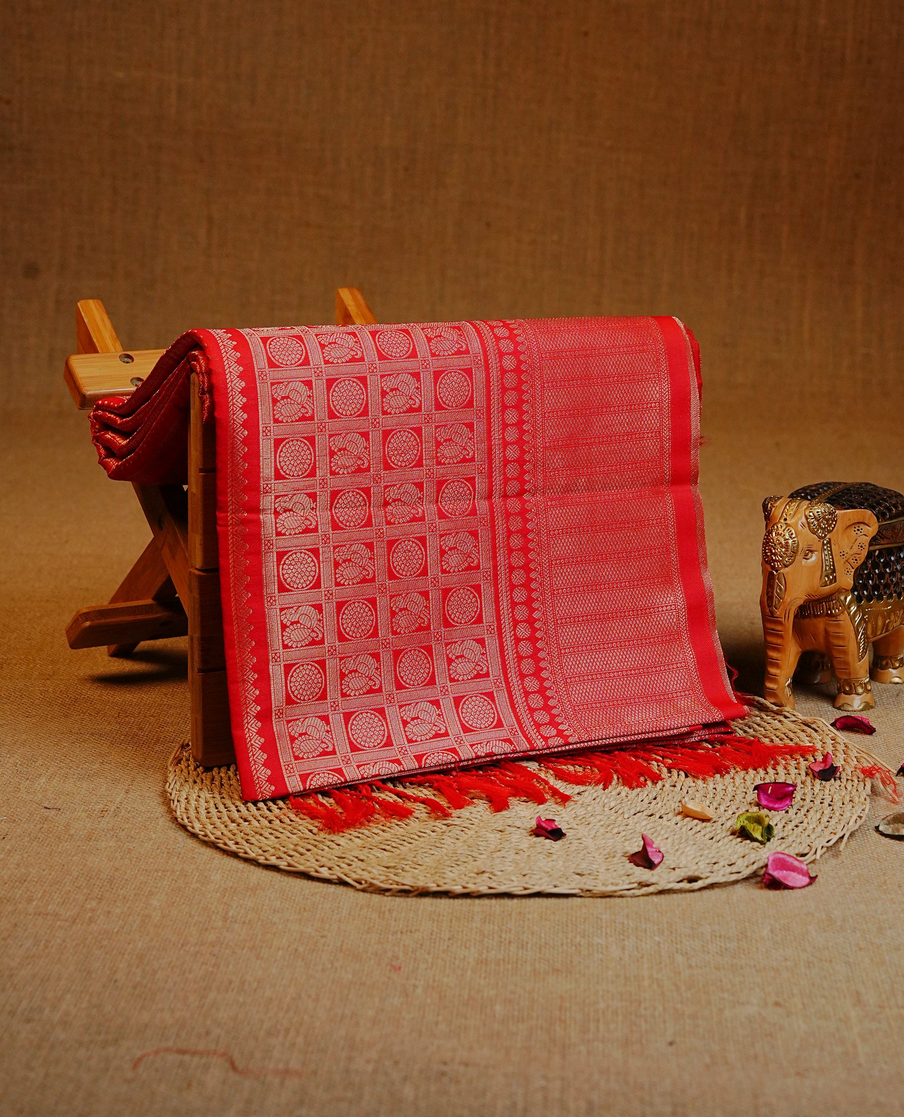 Red Colour Semi Soft Silk Saree Featuring Gold Zari Checks With Delicate Motifs And Stripes Across The Body, Enhanced With A Self Coloured Gold Zari Border, And Paired With A Matching Blouse Piece.