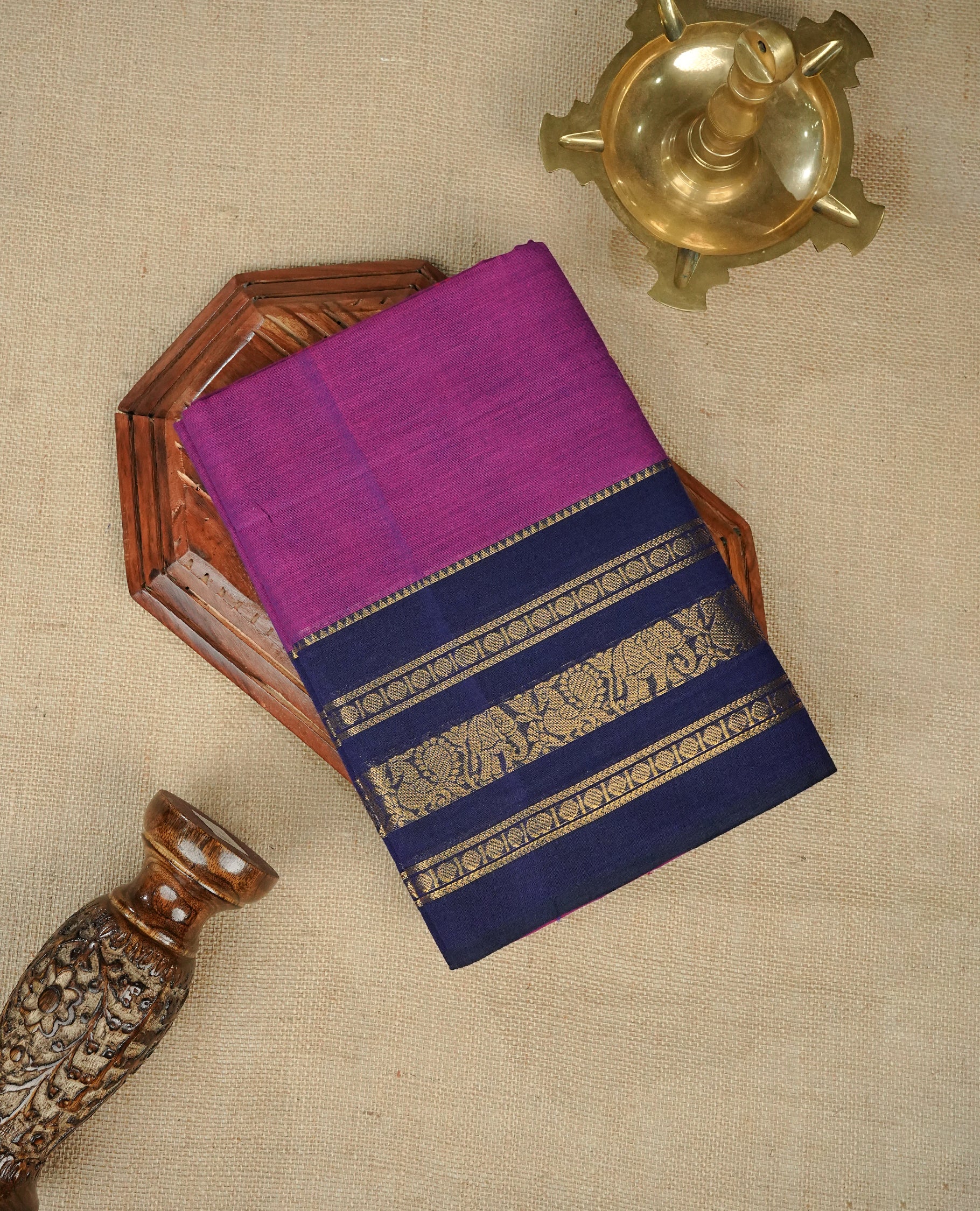 Pinkish Purple Colour Chettinad Cotton Saree Featuring a Plain Body, Complemented by a Navy Blue Colour with Gold Zari Border & Contrast Colour Striped Pallu, Paired with a Matching Blouse Piece.