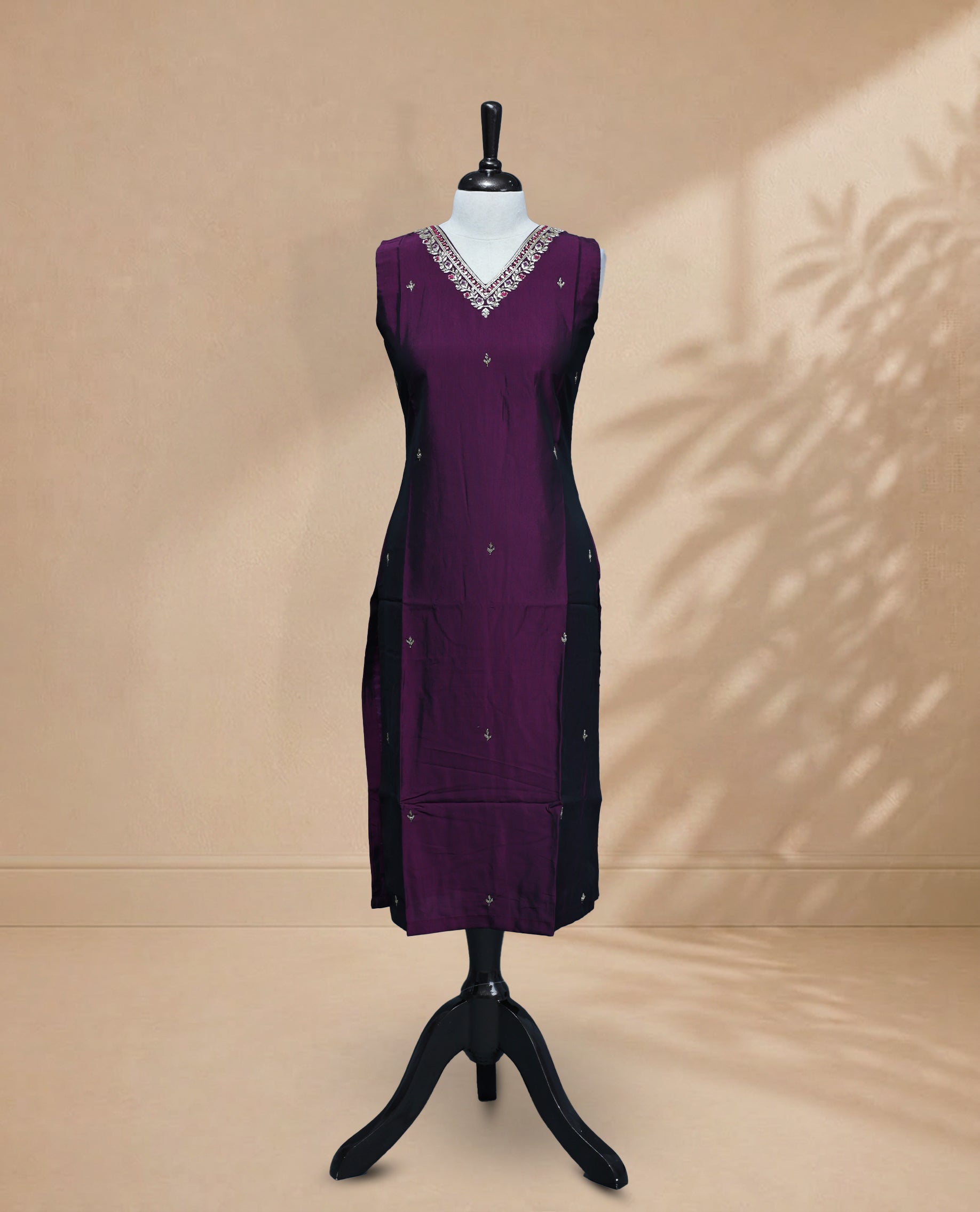 Purple Colour Kurti featuring beadwork across the body, a V-shaped neckline adorned with bead and mirror work and a sleeveless design.