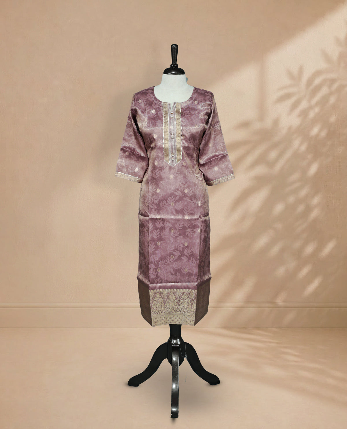 Lavender colour Kurti featuring an intricate floral pattern, a U-shaped neckline adorned with detailed Stone & thread work, and 3/4 sleeves Design