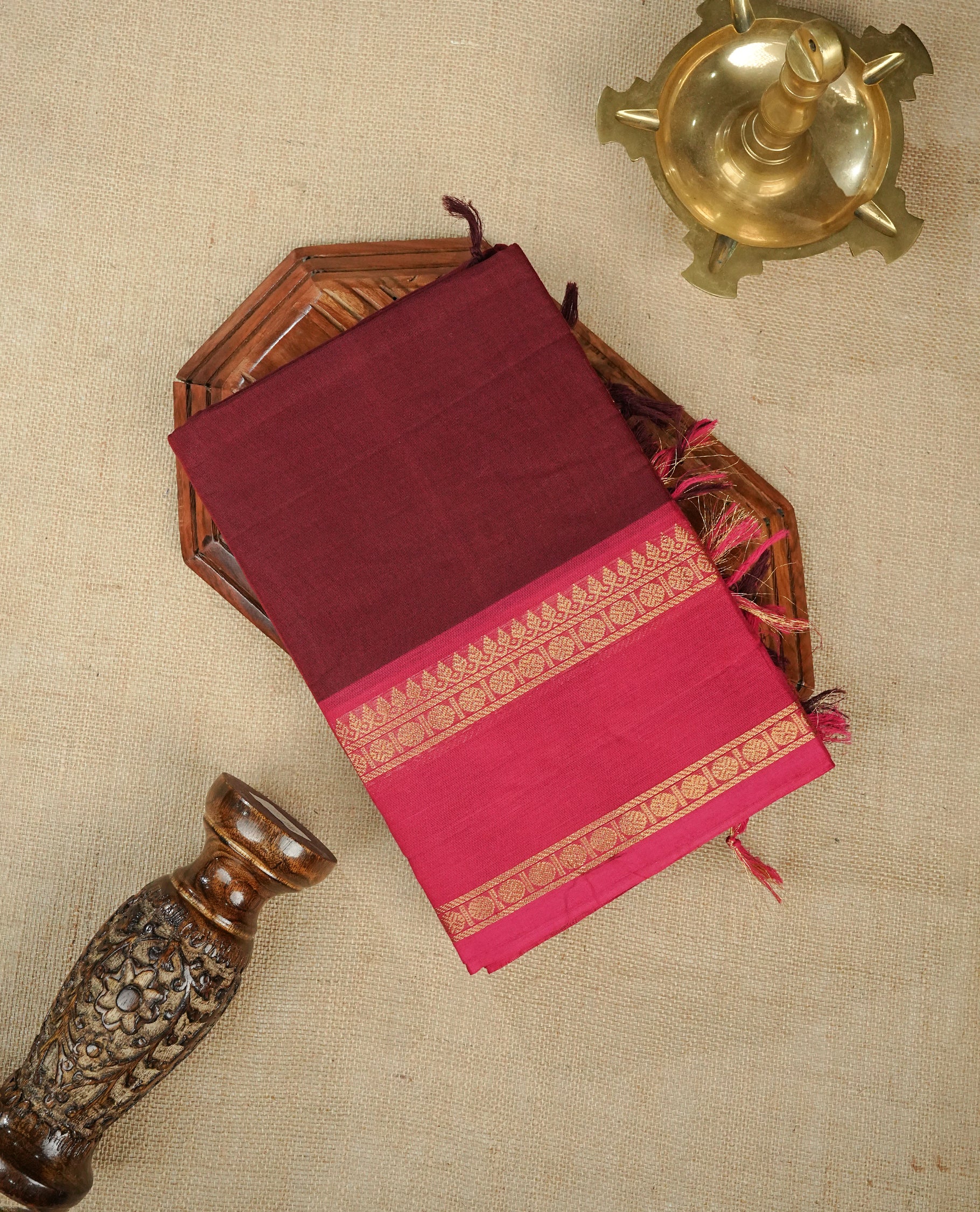 Redish brown colour chettinad cotton saree featuring gold zari motifs on body, Contrast magenta colour with Gold zari border, comes with matching blouse piece.