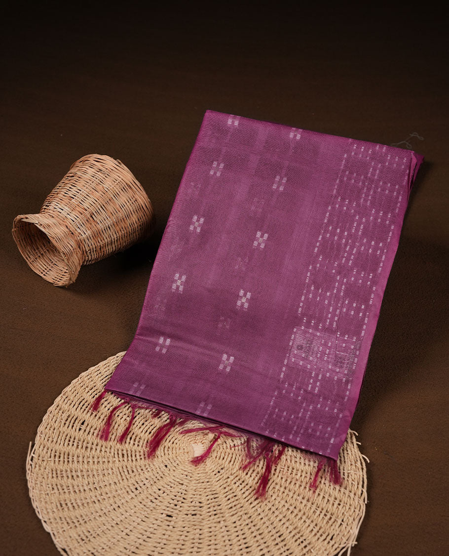 Dark Magenta purple colour semi jute saree highlighting white thread motifs on body, without border and paired with matching blouse.
