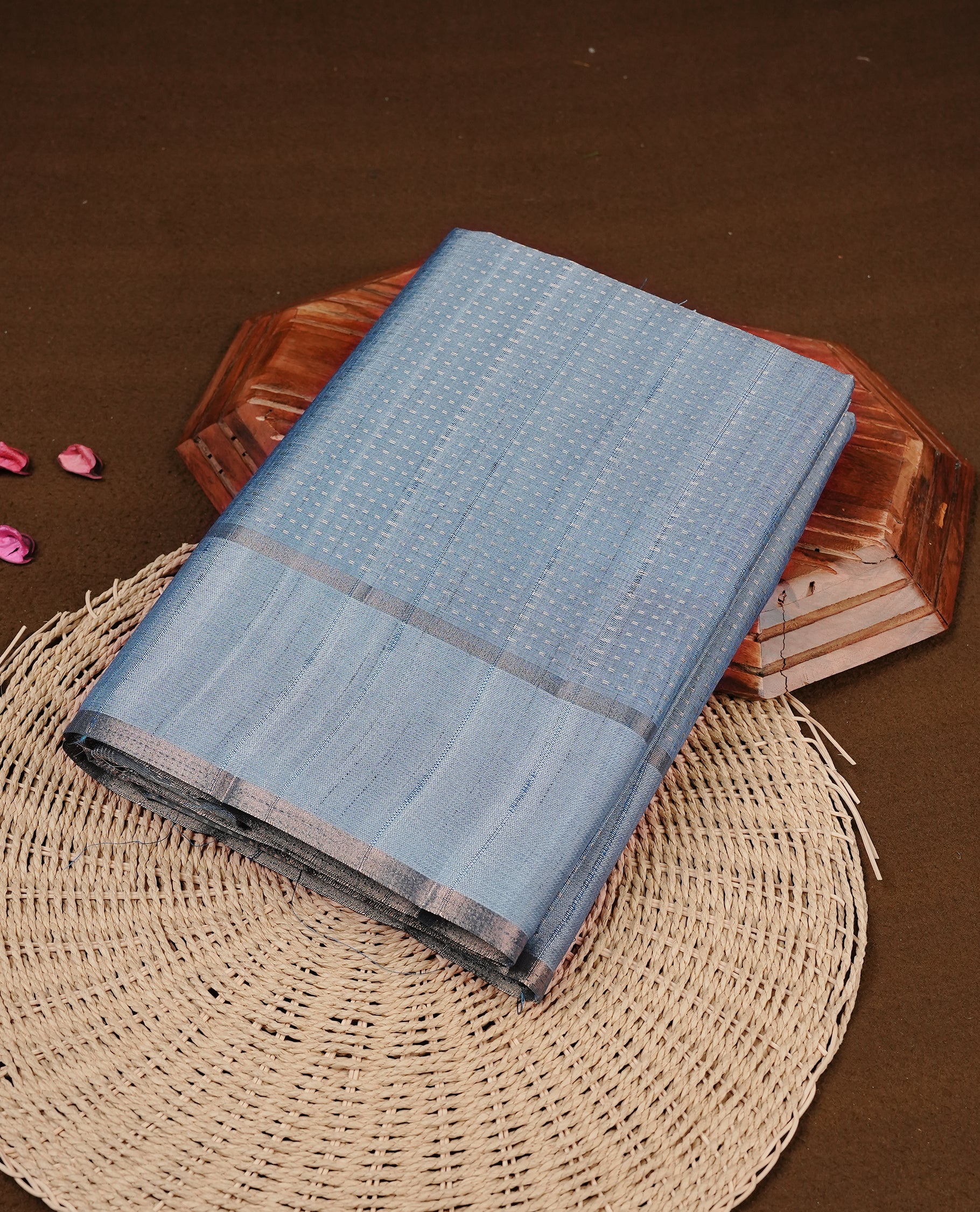 Steel blue colour semi tussar silk saree featuring elegant gold zari dotted stripes across the body, enhanced with a rich zari woven border. Comes with a matching blouse piece.