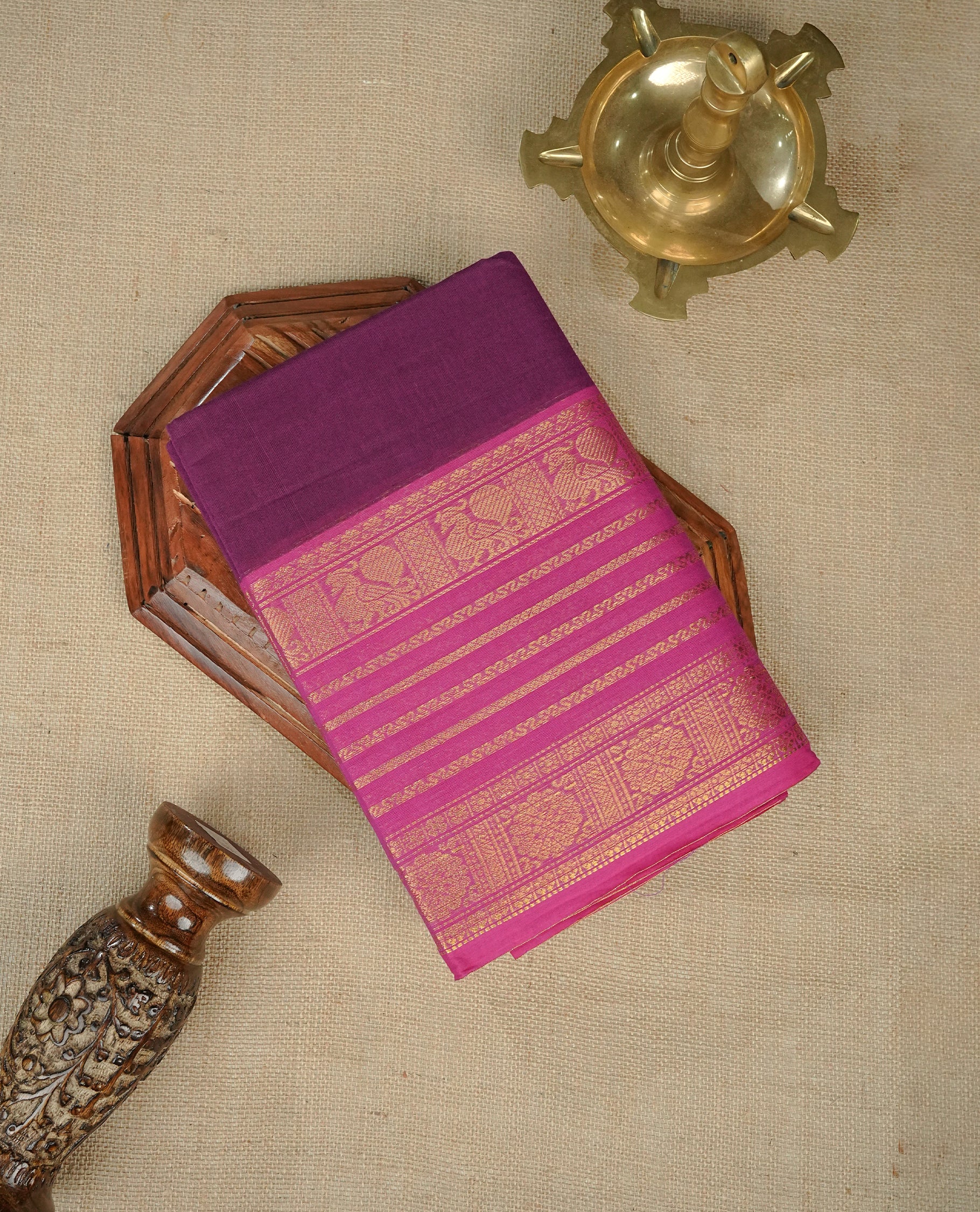 Purple colour chettinad cotton saree featuring Elegant plain body, complemented by contrast Magenta colour with gold zari strip & peacock border, comes with matching blouse piece.