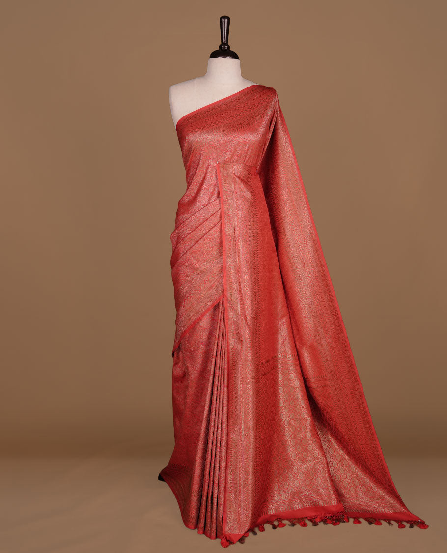 Red colour semi banaras katan saree featuring Gold zari Pattern across body, complemented by self colour with zari border, paired with matching blouse piece.