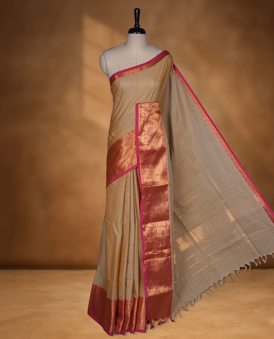 Beige colour chettinad cotton saree featuring Elegant plain body, contrast Magenta colour border with gold zari border, pallu and paired with matching blouse.