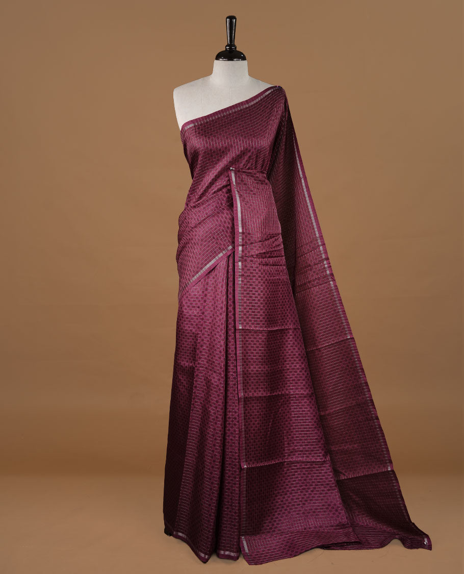 Grape colour Semi Tussar saree featuring an elegant zari fancy check pattern on the body, highlighted with a small border for a refined look. Comes without a blouse piece.