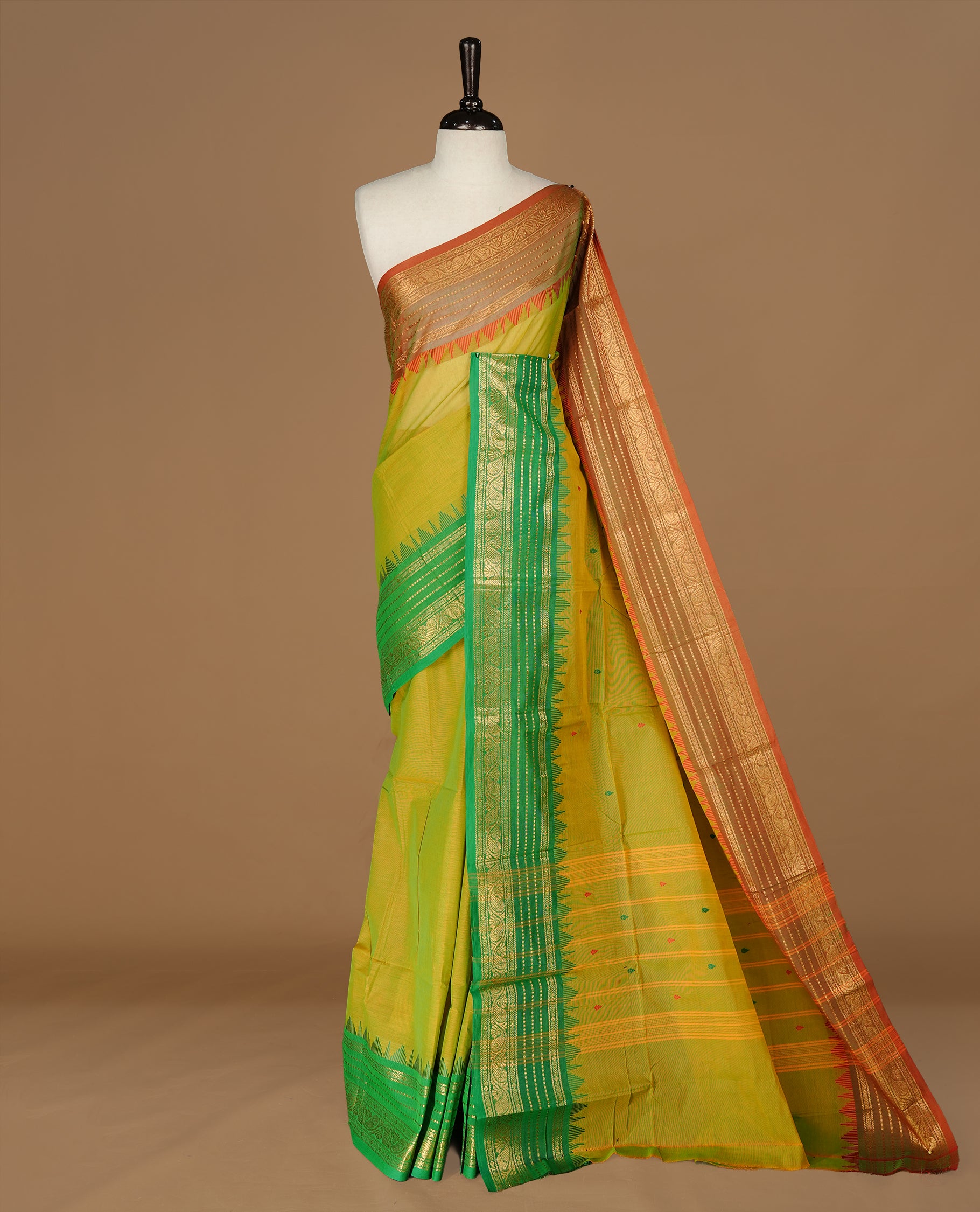 Moderate Olive colour Chettinad cotton saree featuring motifs on body , complemented by contrast Green colour with zari border, comes with matching blouse piece.