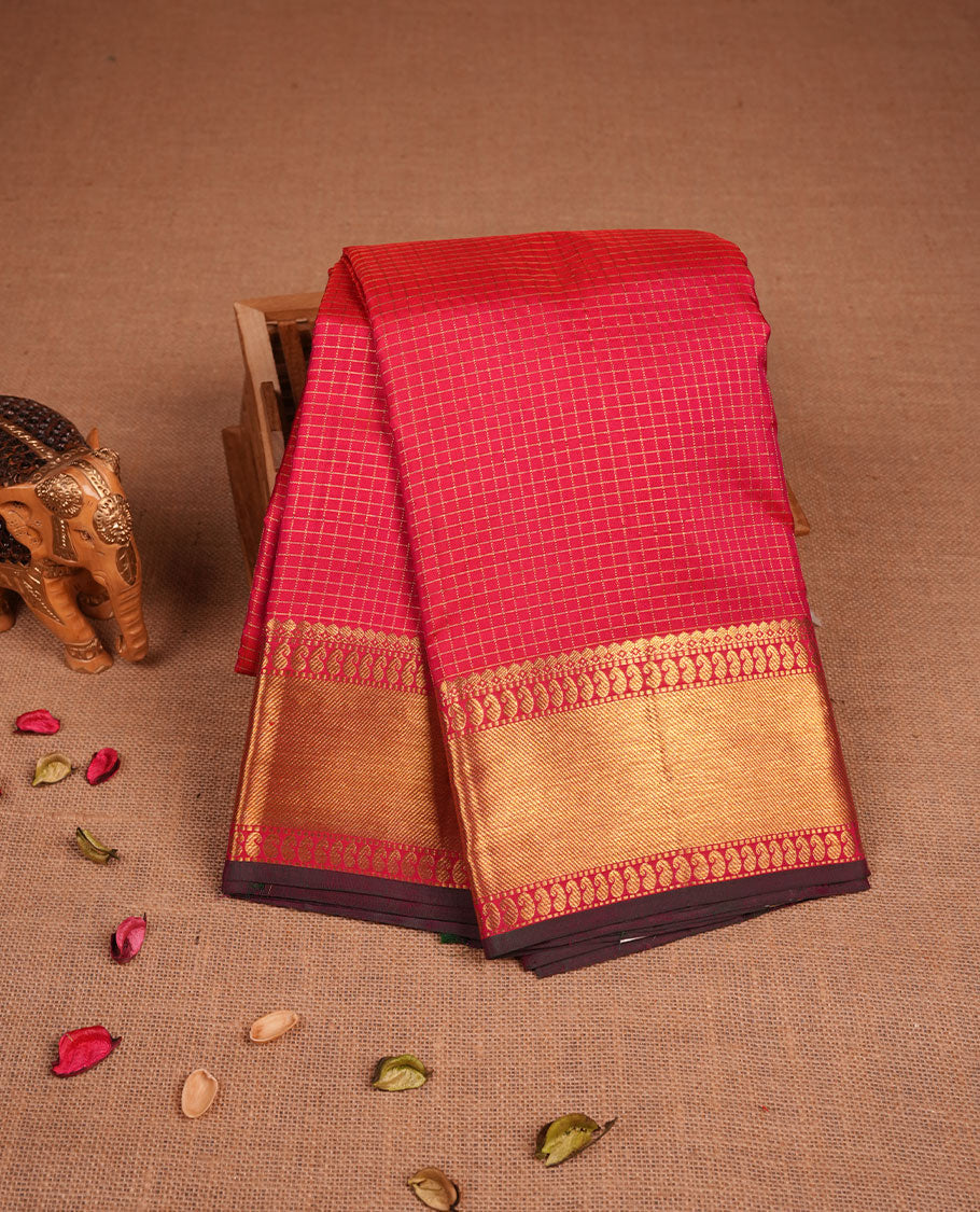 Rani Pink colour pure traditional Kancheepuram silk saree adorned with gold zari Checks across the body, featuring elegant traditional borders, beautifully paired with a matching blouse piece.