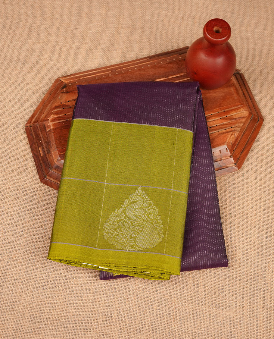 Jamun fruit colour soft silk saree featuring rain drop stripes on body, complemented by contrast henna green with peacock buttas border, paired with matching blouse piece.