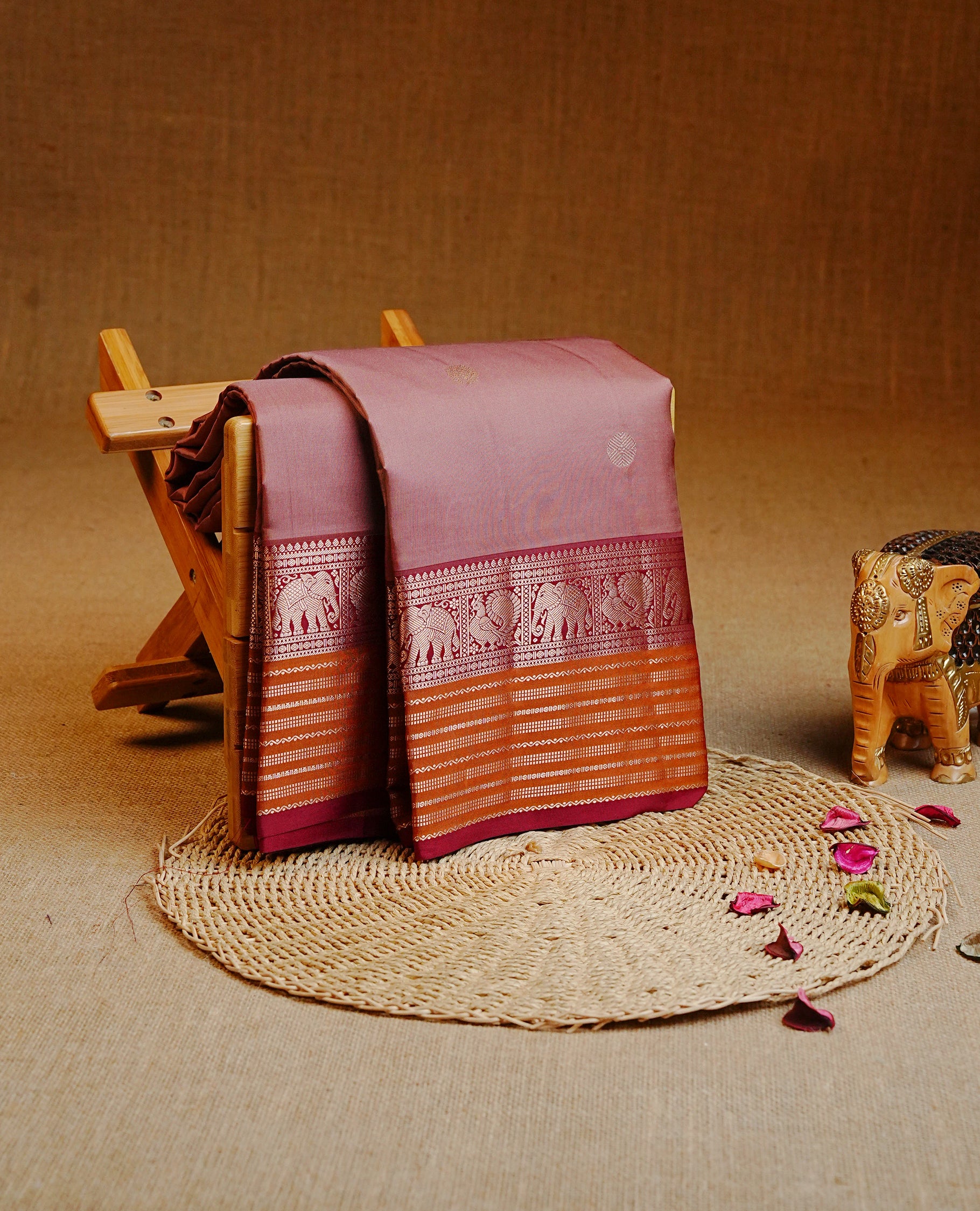 Light Mauve Colour Kancheepuram silk saree featuring gold zari circle motifs on body, highlighting Gold zari Elephant & Peacock Traditional On contrast Maroon & mustard border, paired with Matching blouse piece.