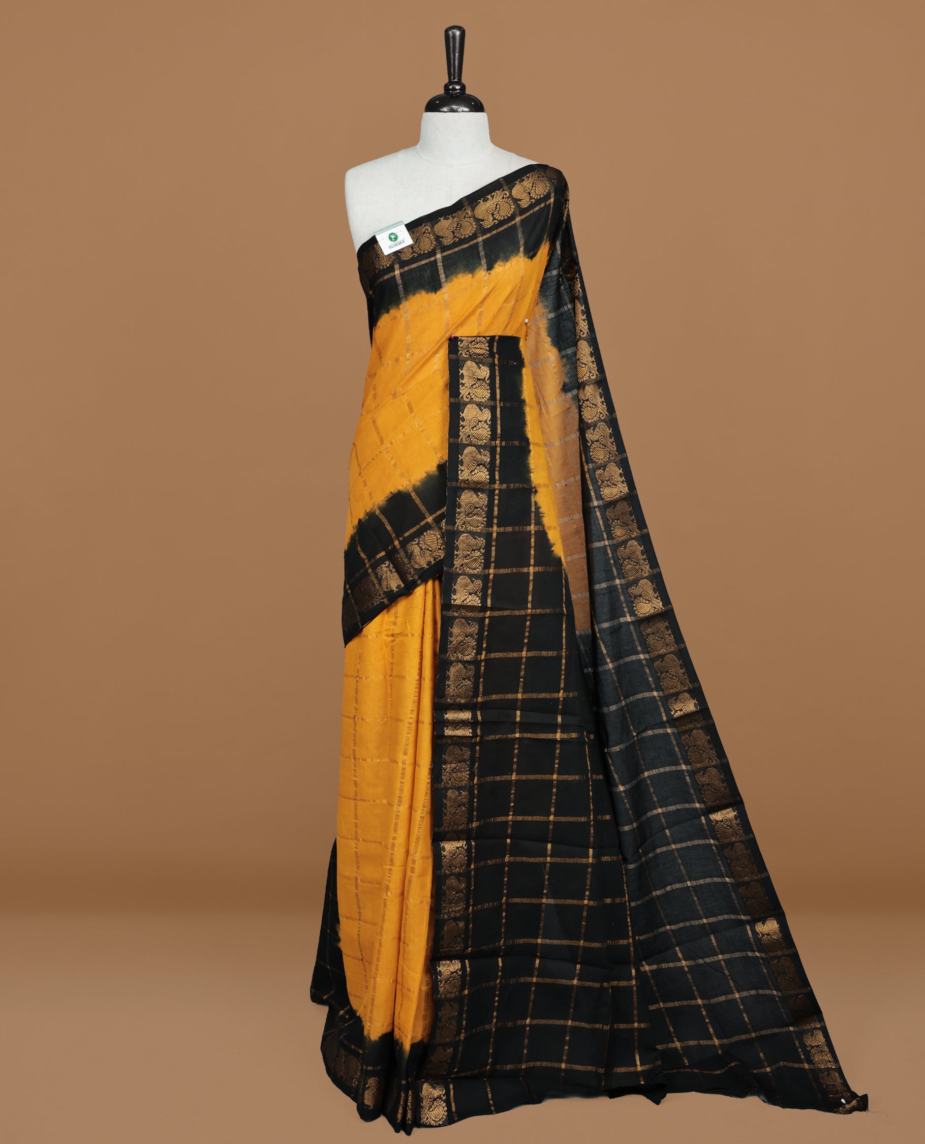 Mustard colour Sungudi cotton saree featuring Gold zari Check pattern on body, Gold zari Peacock design on Dyed Black colour design border, paired with matching blouse piece.