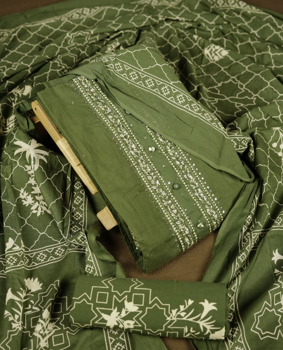 Dark green colour churidar set with stone and thread embroidery and detailing, paired with matching pant and dupatta.
