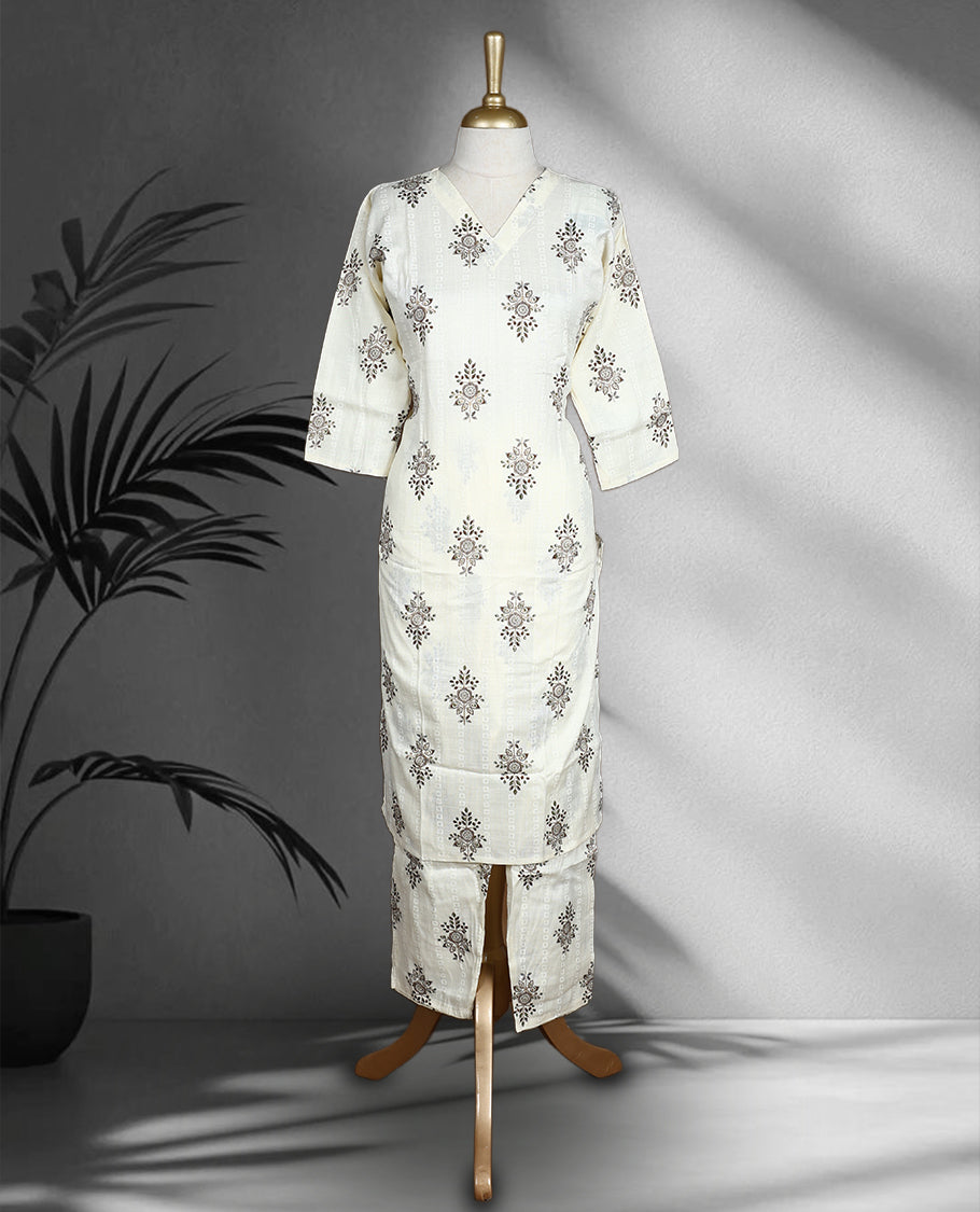 Off white colour Cord set with brown and green floral block print, featuring a V neck top with a straight cut silhouette and side slits, paired with matching straight fit pants.