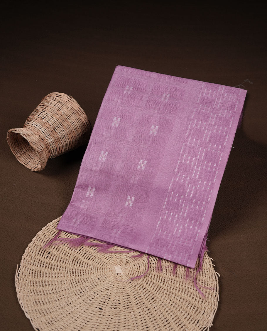 Light lavender colour semi jute saree highlighting white thread motifs on body, without border and paired with matching blouse.