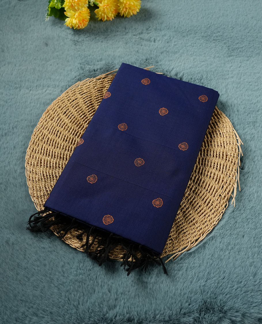 Navy blue colour poly cotton saree with orange abstract butti motifs on the body, paired with a matching pallu with dense orange textured round butta pattern, and a coordinated all‑over textured round butta printed blouse piece.