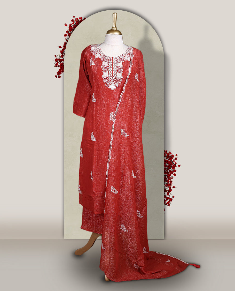 Orange colour churidar set featuring elegant white thread embroidery on the neckline, sleeves, and scattered motifs across the body, Paired with a matching embroidered dupatta, this ensemble radiates graceful charm and festive appeal.