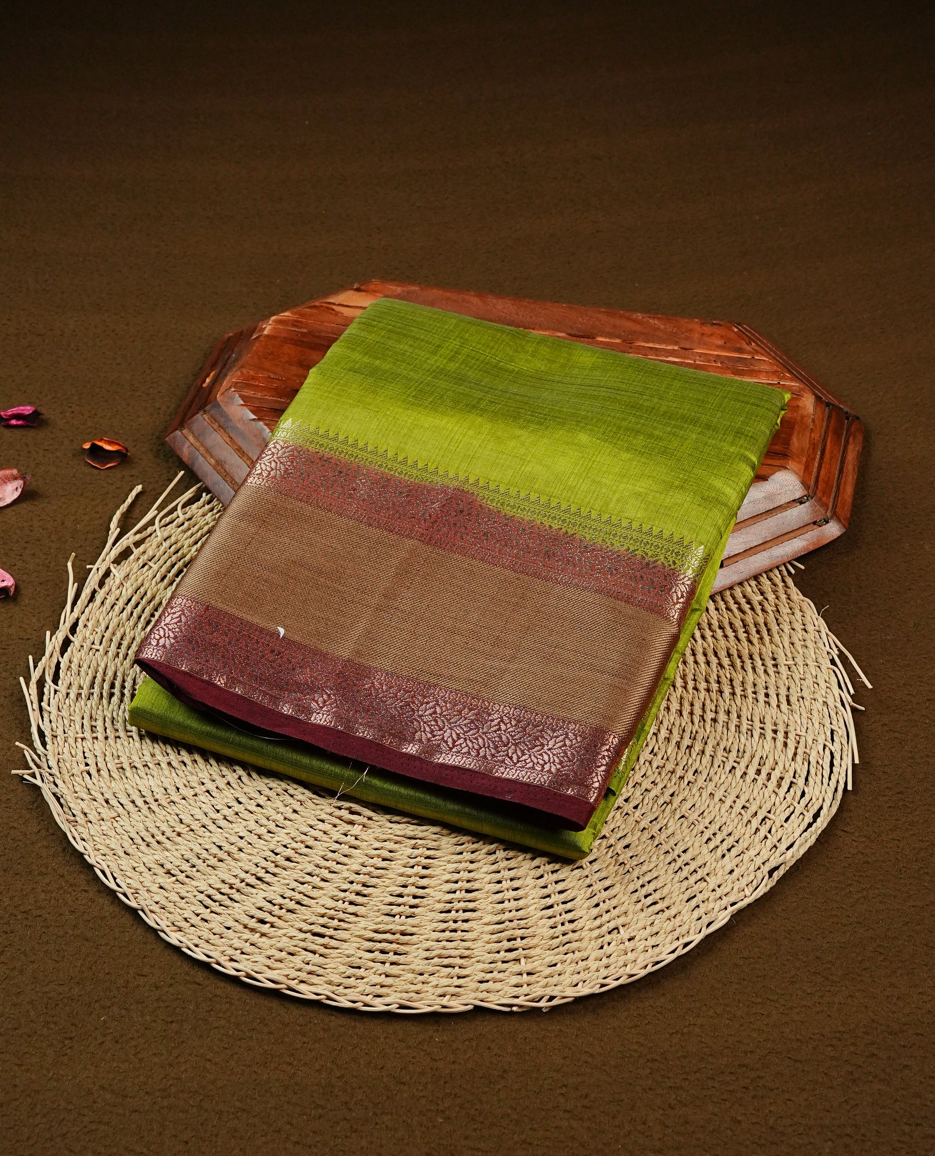 Green colour Tussar saree featuring Elegant plain body, complemented by Contrast chocolate colour with traditional border, comes with matching blouse piece.