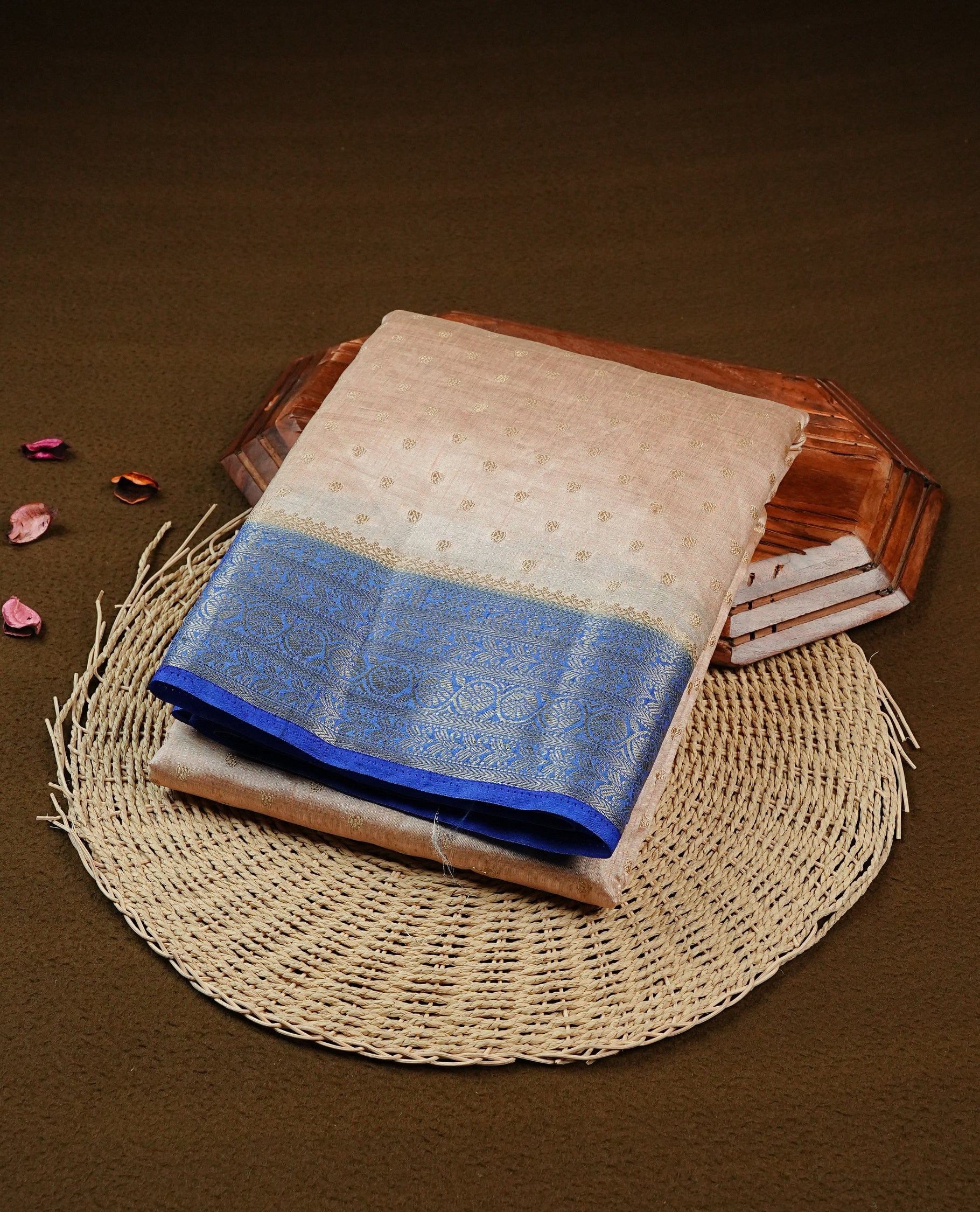 Light Gold Tussar saree featuring Gold zari buttas on body, complemented by contrast Blue Colour with Gold zari border, comes with matching blouse piece.