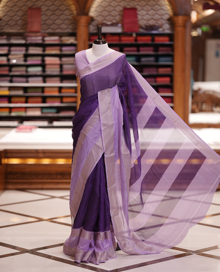 Royal purple colour saree featuring fine check patterns on the body, paired with a lavender zari woven border and pallu. Comes with a matching blouse piece