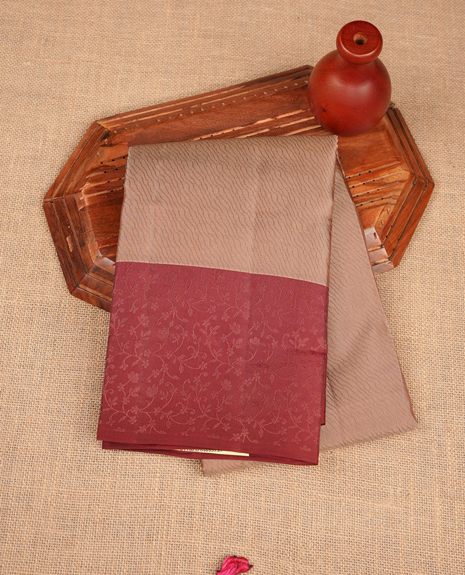 Beige colour soft silk saree featuring zari pattern on body, complemented by contrast brown zari patterned border, and paired with matching blouse piece.