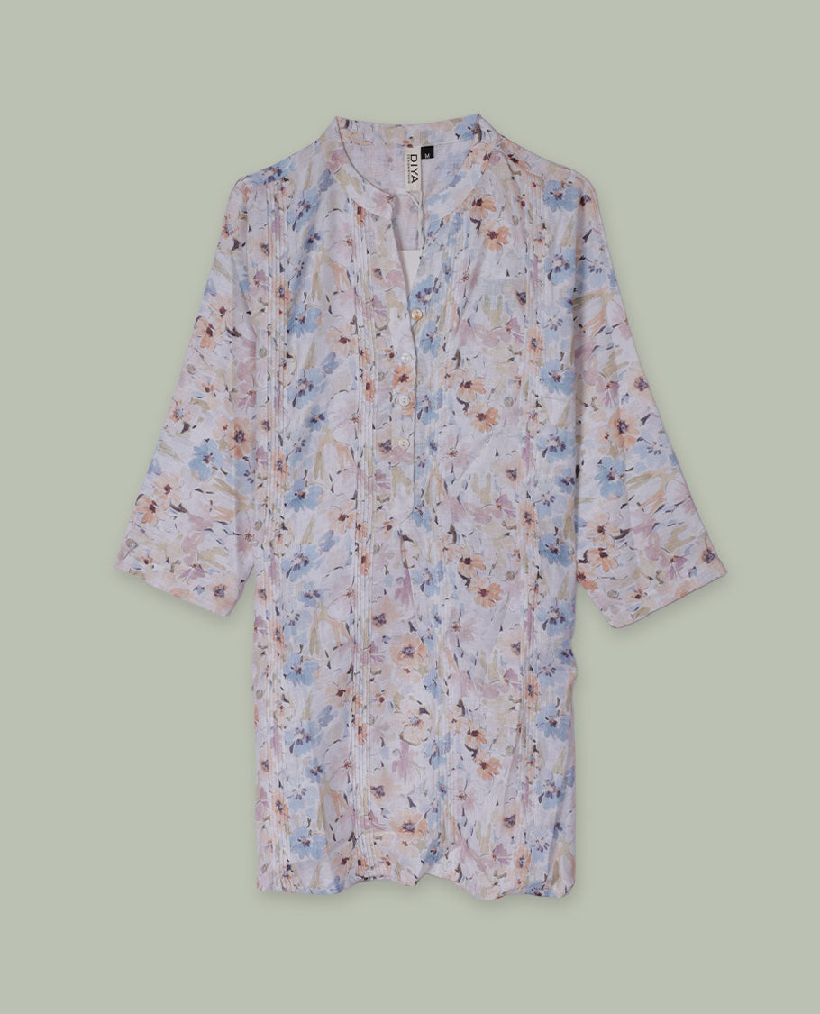 Pastel floral printed tunic top with band collar, pintuck-detailed front, half button placket, and three-quarter sleeves.