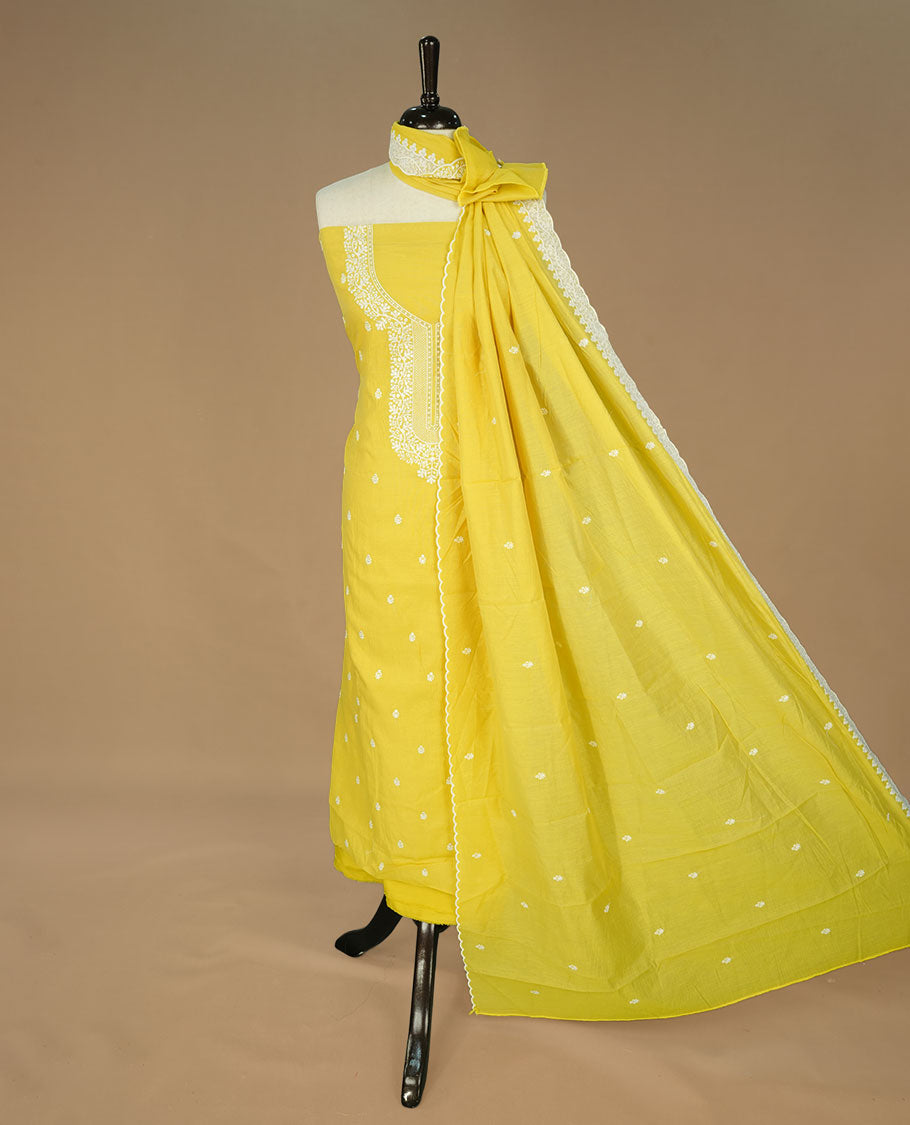 Yellow colour churidhar material featuring cream colour floral thread pattern on body, paired with matching bottom and Dupatta.