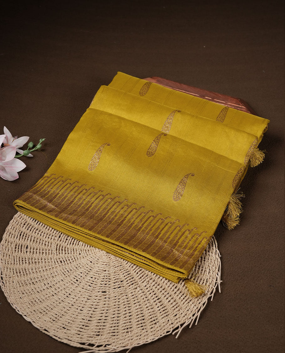 Yellow colour semi banaras tussar georgette featuring gold zari leaf pattern across body, finished with gold zari border and paired with matching blouse.