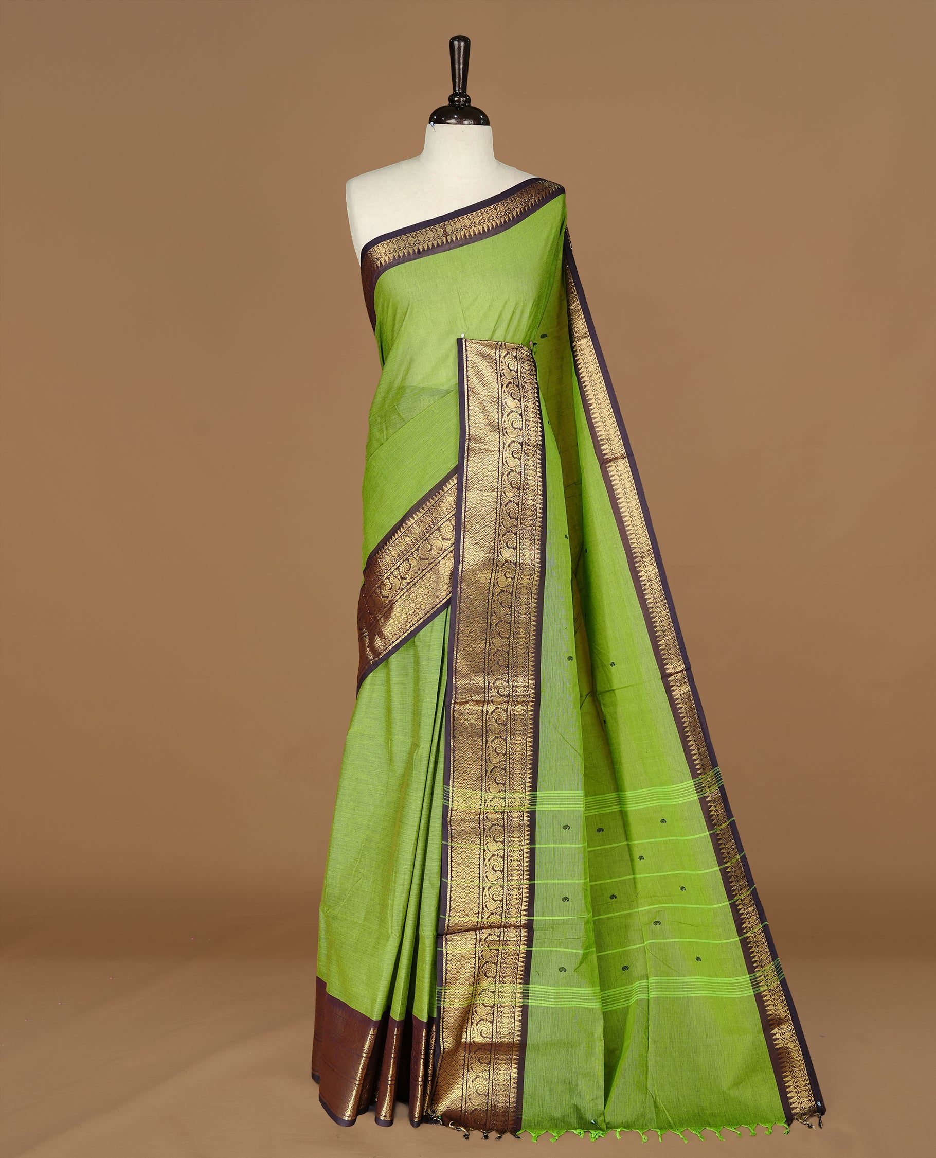 Green colour Chettinad cotton saree featuring motifs on body , complemented by contrast DarkBlue colour with zari border, comes with matching blouse piece.