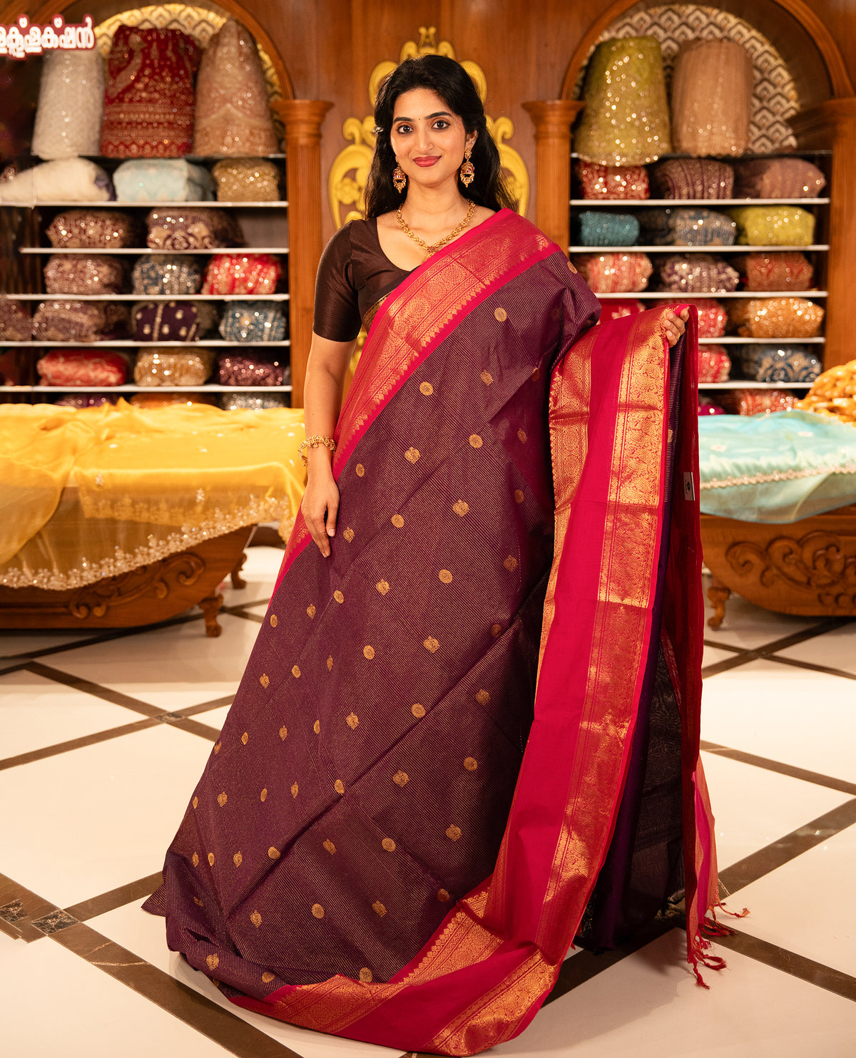 Purple with Magenta Chettinad cotton saree featuring Gold zari strips with peacock motifs on body, complemented by contrast colour border with zari design & grand pallu, comes with matching blouse piece.