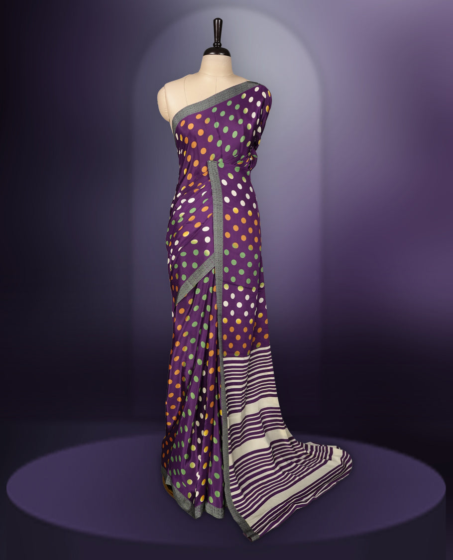 Purple colour saree with with large big polka dots on the body, self stripped pallu & Comes with a stylish matching blouse.