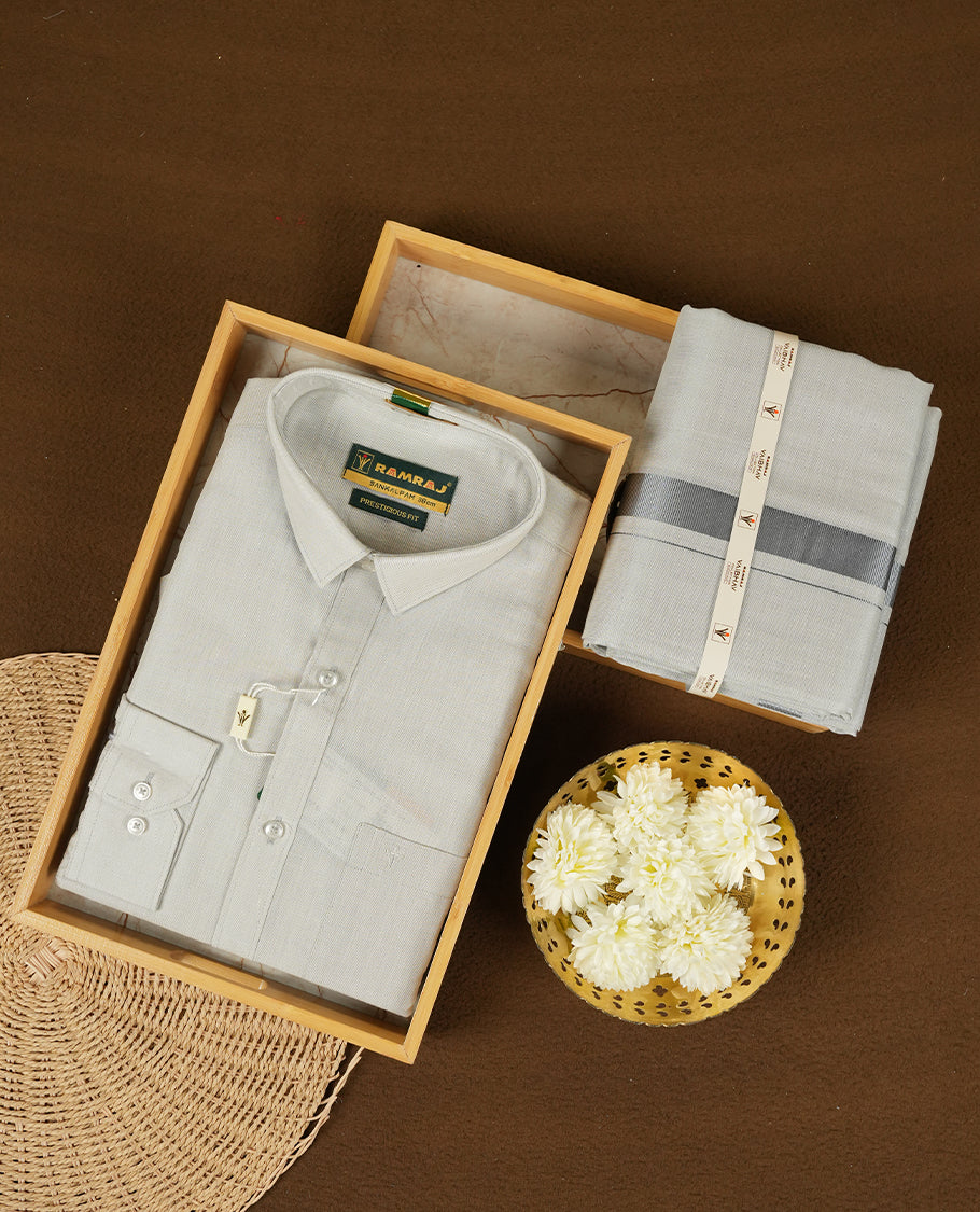 Blue Silver Colour shirt by RAMRAJ paired with a matching dhoti, all elegantly finished with a Blue silver border.