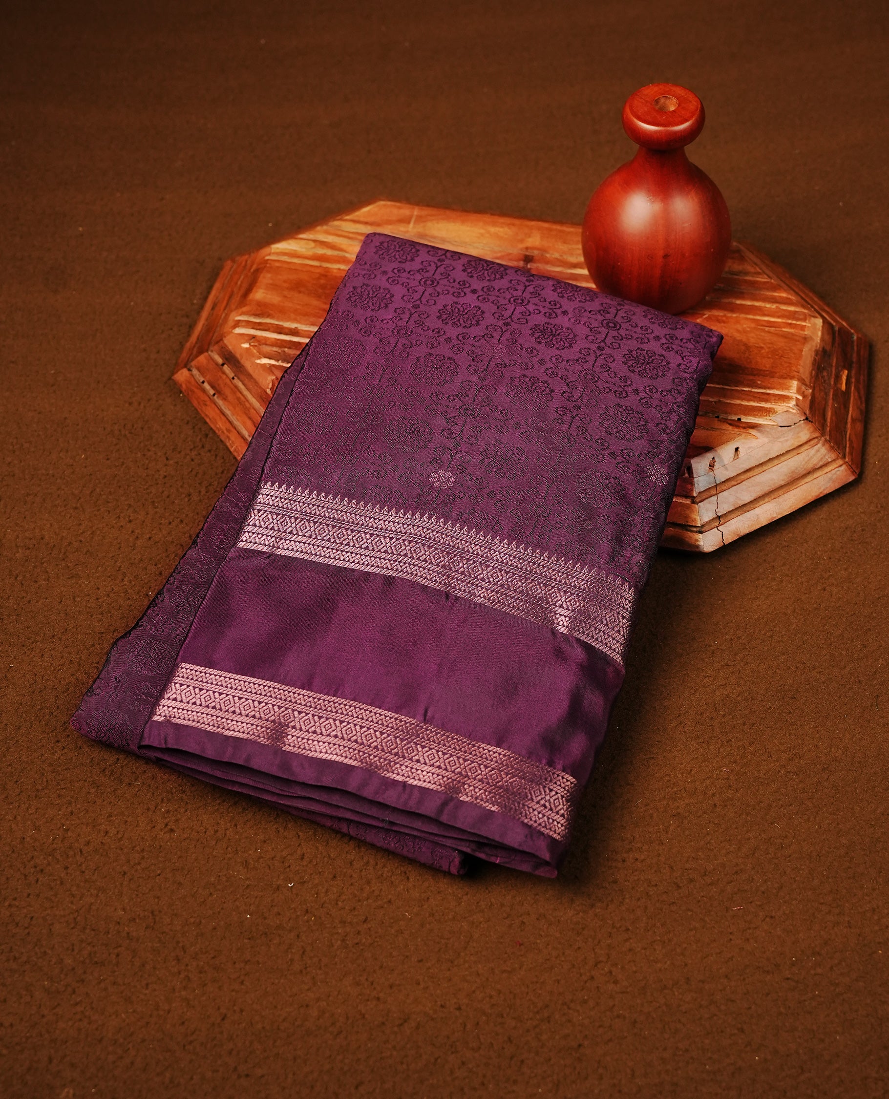 Grape Colour Semi Soft Slik Saree Featuring An Elegant Self Floral Woven Body, Enhanced By A Traditional Rose Gold Zari Border And Rich Pallu, Paired With A Matching Blouse Piece.