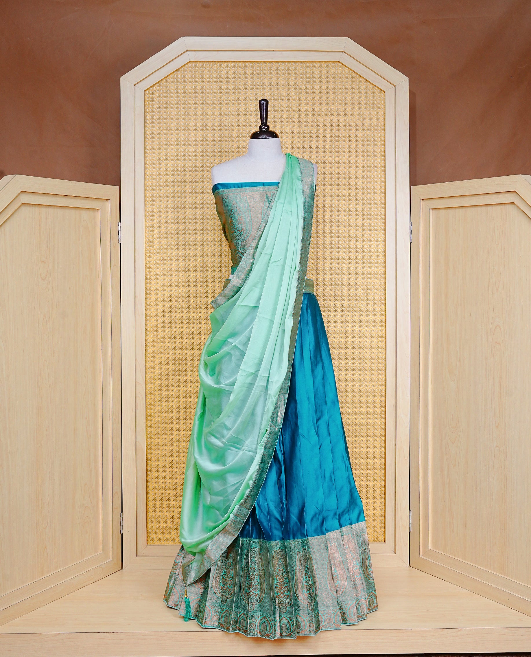 Teal Green colour Half saree featuring Plain skirt with Zari border on contrast Light green colour border, Unstitched Blouse and matching dupatta.