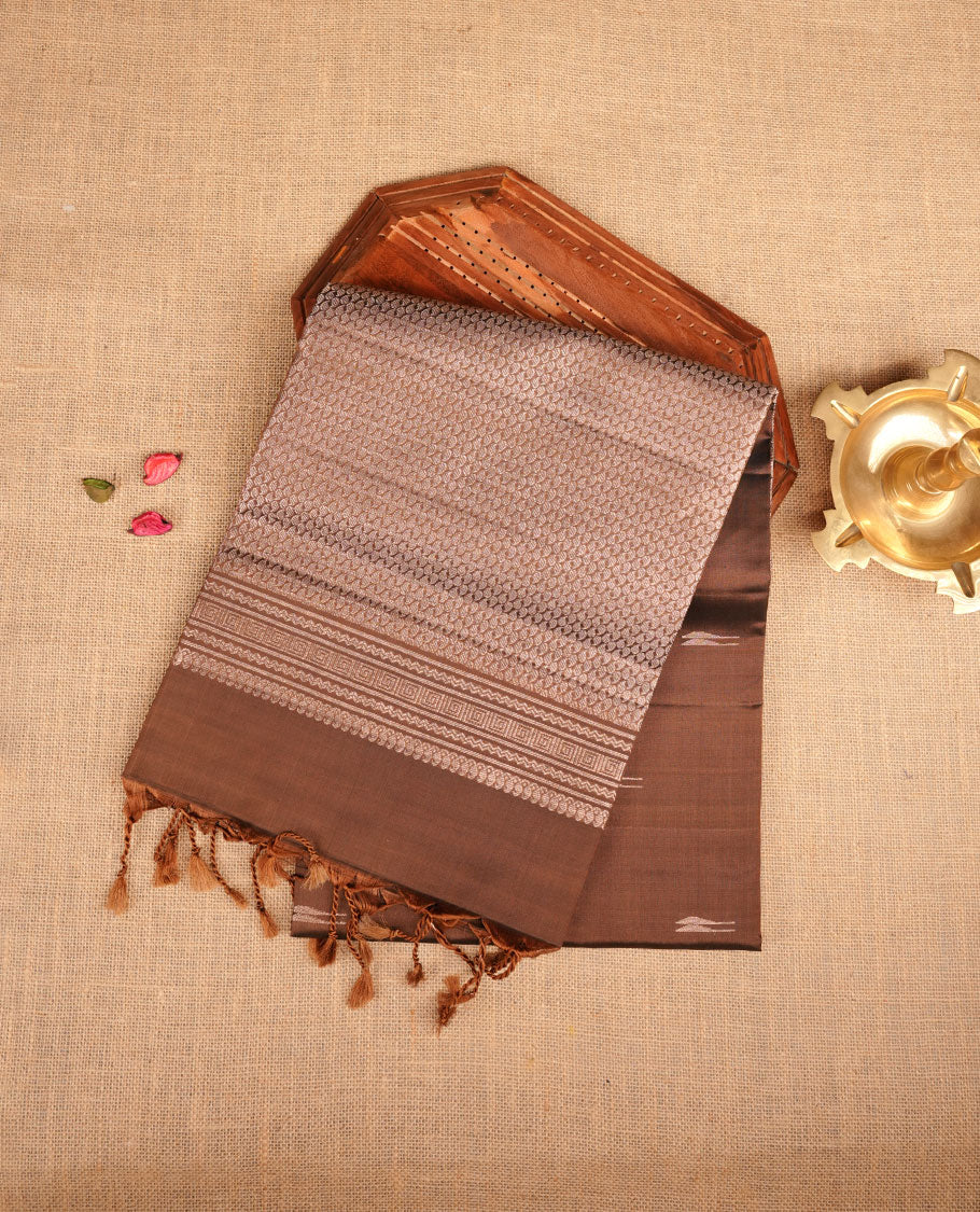 Olive Brown colour soft silk saree featuring gold zari motifs on body, complemented by self colour with traditional border with tassel at pallu, paired with matching blouse piece.