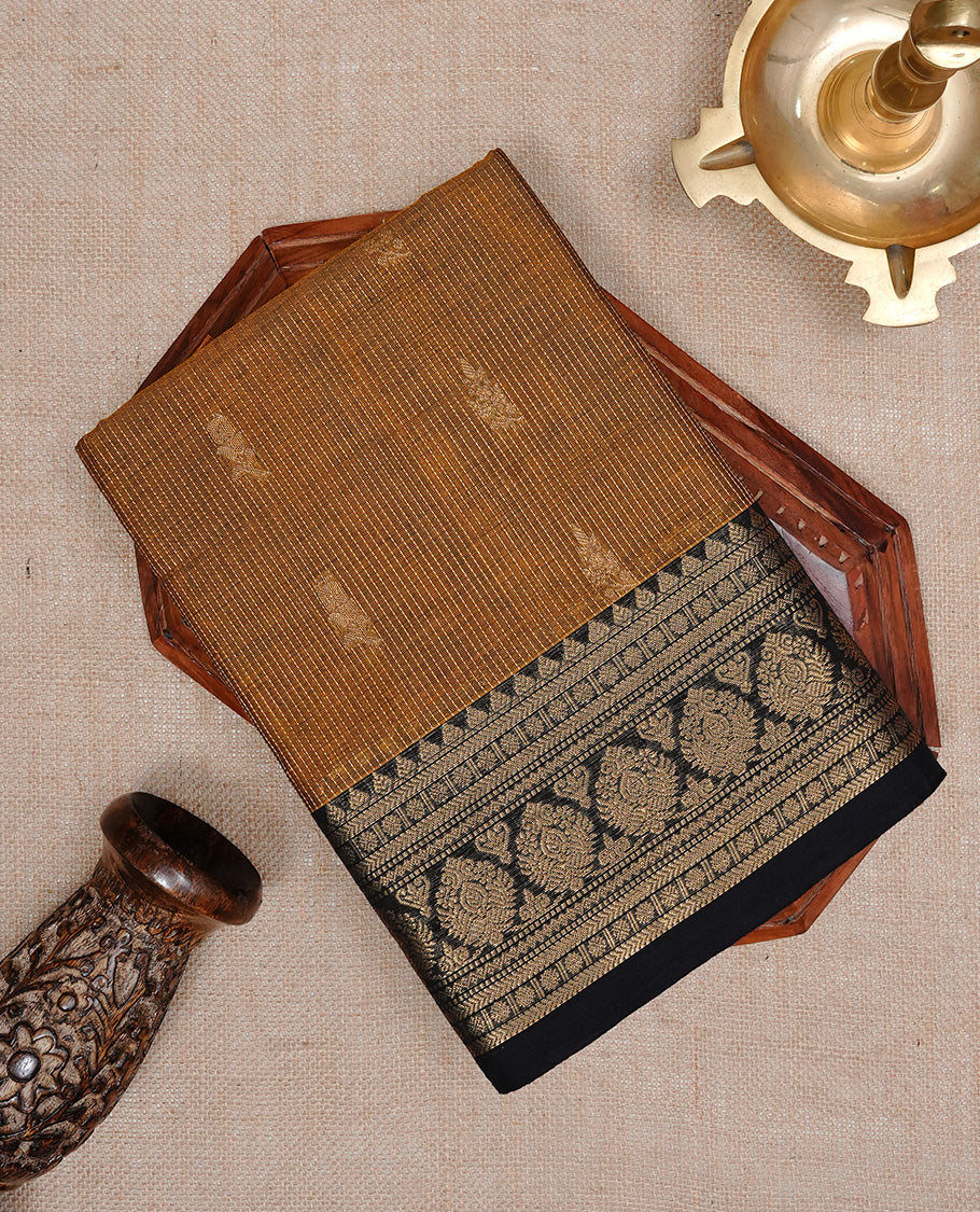Mustard colour chettinad cotton saree featuring gold zari stripes & motifs on body, complemented by Contrast Black colour with zari border, paired with matching blouse piece.