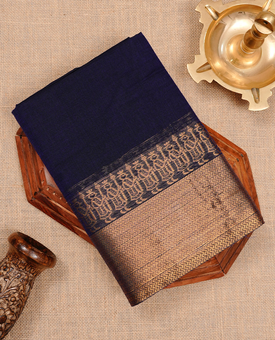 Navy blue colour chettinad cotton saree featuring elegant plain body, complemented by self colour with zari border, paired with matching blouse piece.